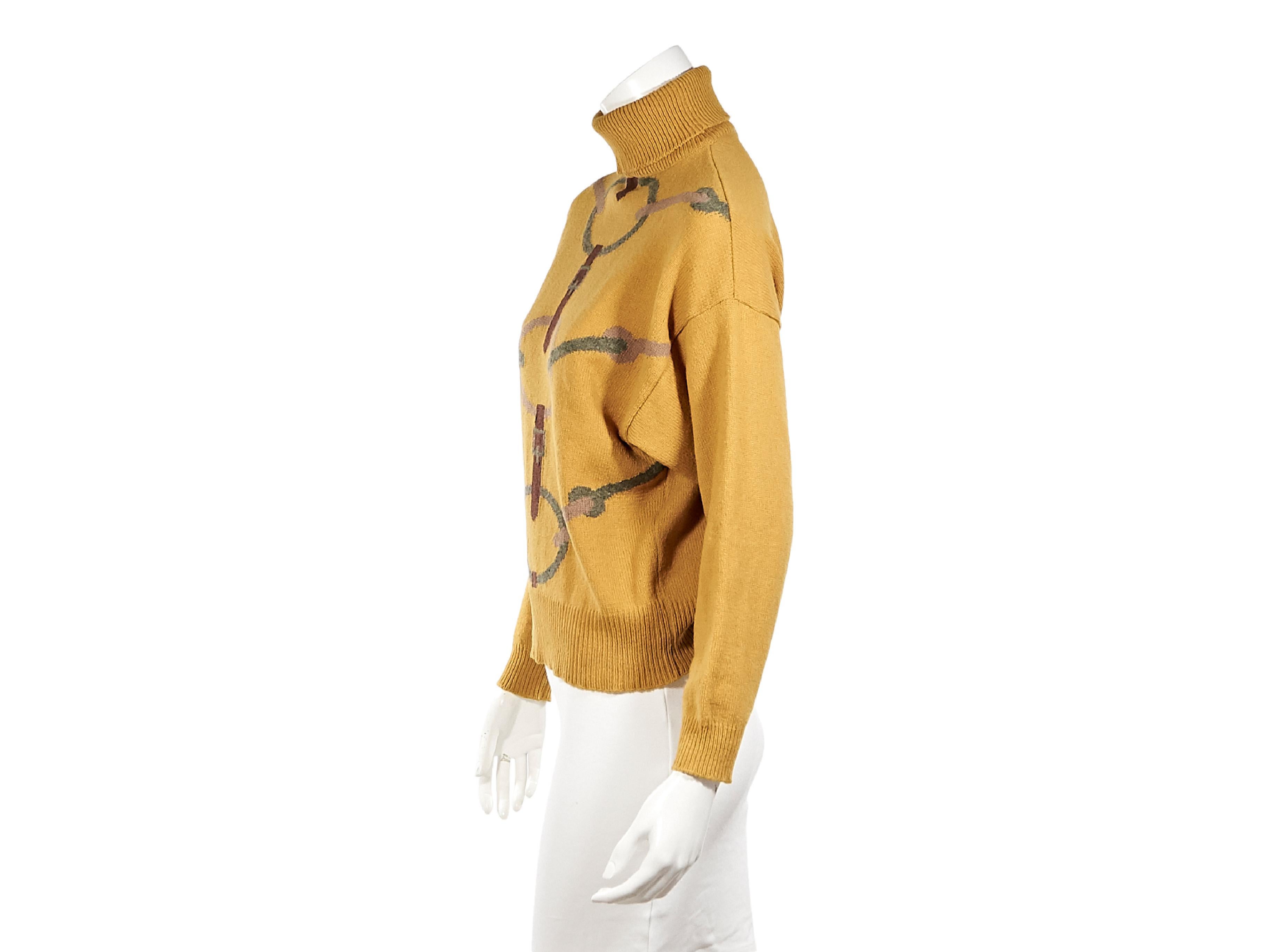 Product details:  Vintage mustard yellow wool turtleneck sweater by Hermes.  Horsebit front design.  Long sleeves.  Ribbed cuffs and hem.  Pullover style.  Label size FR 40.  36