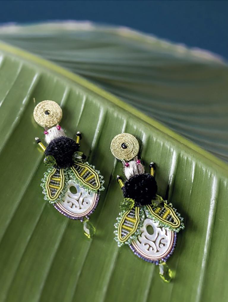Musula Afrikania Savanah  Fly Green Soutache earrings made of rayon yarn 2mm, mother of pearl, silk pompom and crystal beads. 
Silver closure. 
Earring Length 9cm or 3,54inches 
Back finish in natural smooth and thin leather 

READY TO