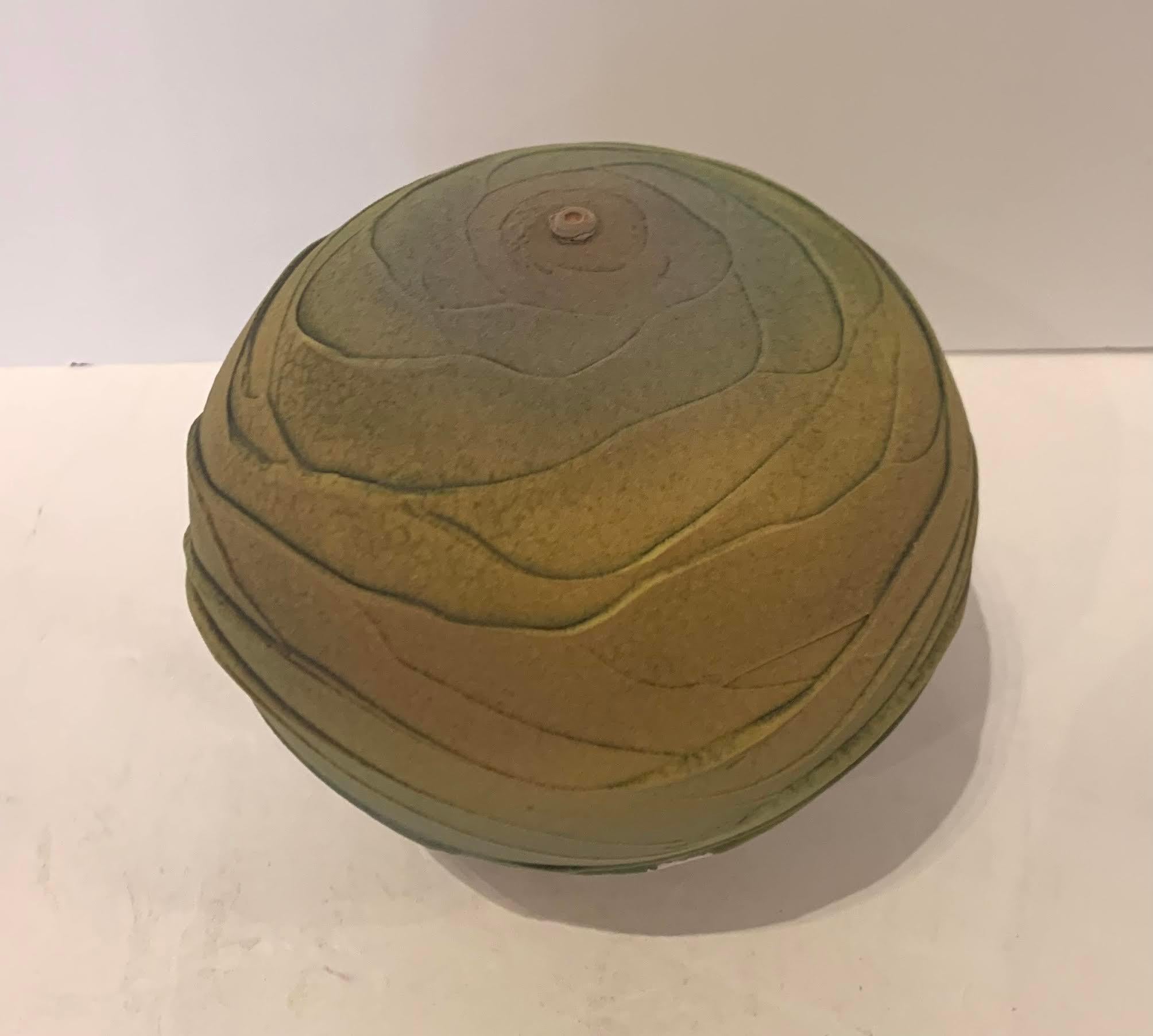 Contemporary textured round ceramic earthenware vase.
Classical shape textural design vase inspired by the landscape. 
Muted shades of green and yellow.
The vase design has an ancient feel.
Hand made one of a kind.
Part of a collection of