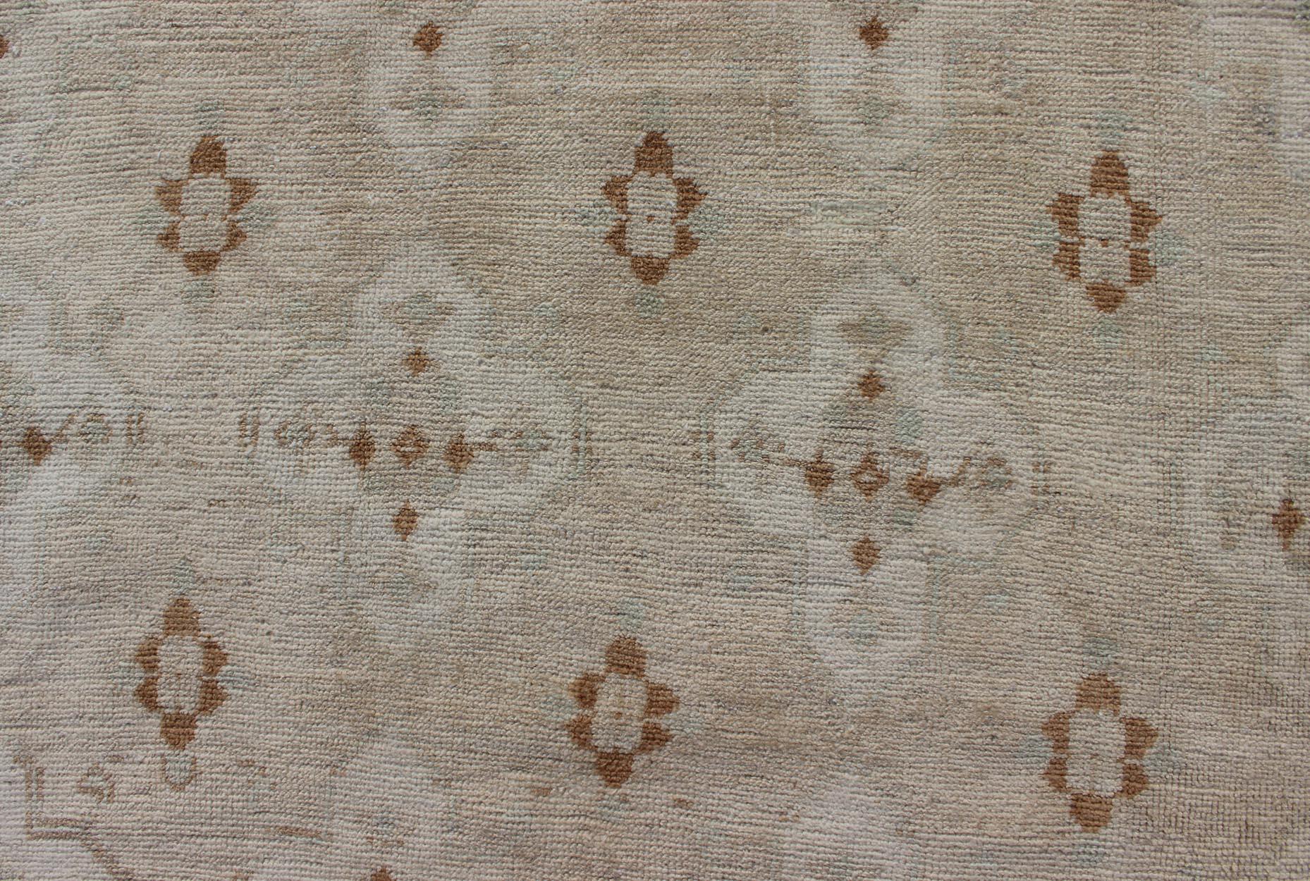 20th Century Muted Oushak with All-Over Tribal Design in Light Tones of Taupe and Browns For Sale