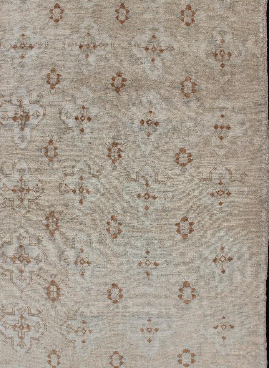 Muted Oushak with All-Over Tribal Design in Light Tones of Taupe and Browns For Sale 1
