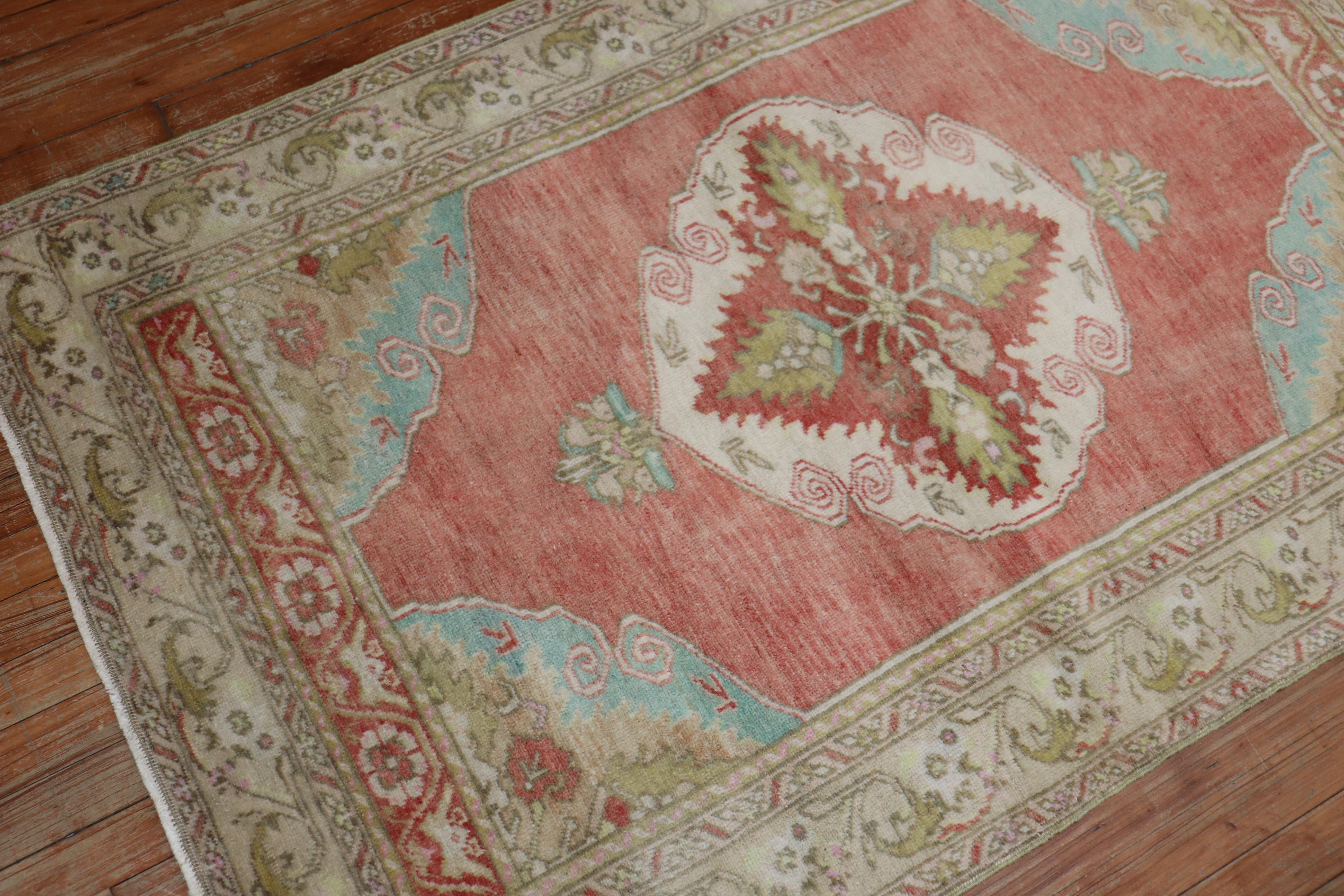 One of a kind vintage Turkish Throw rug from the mid-20th century with a traditional medallion and border design mainly in soft red, powder blue and ivory.

Measures: 3'5'' x 5'6''.