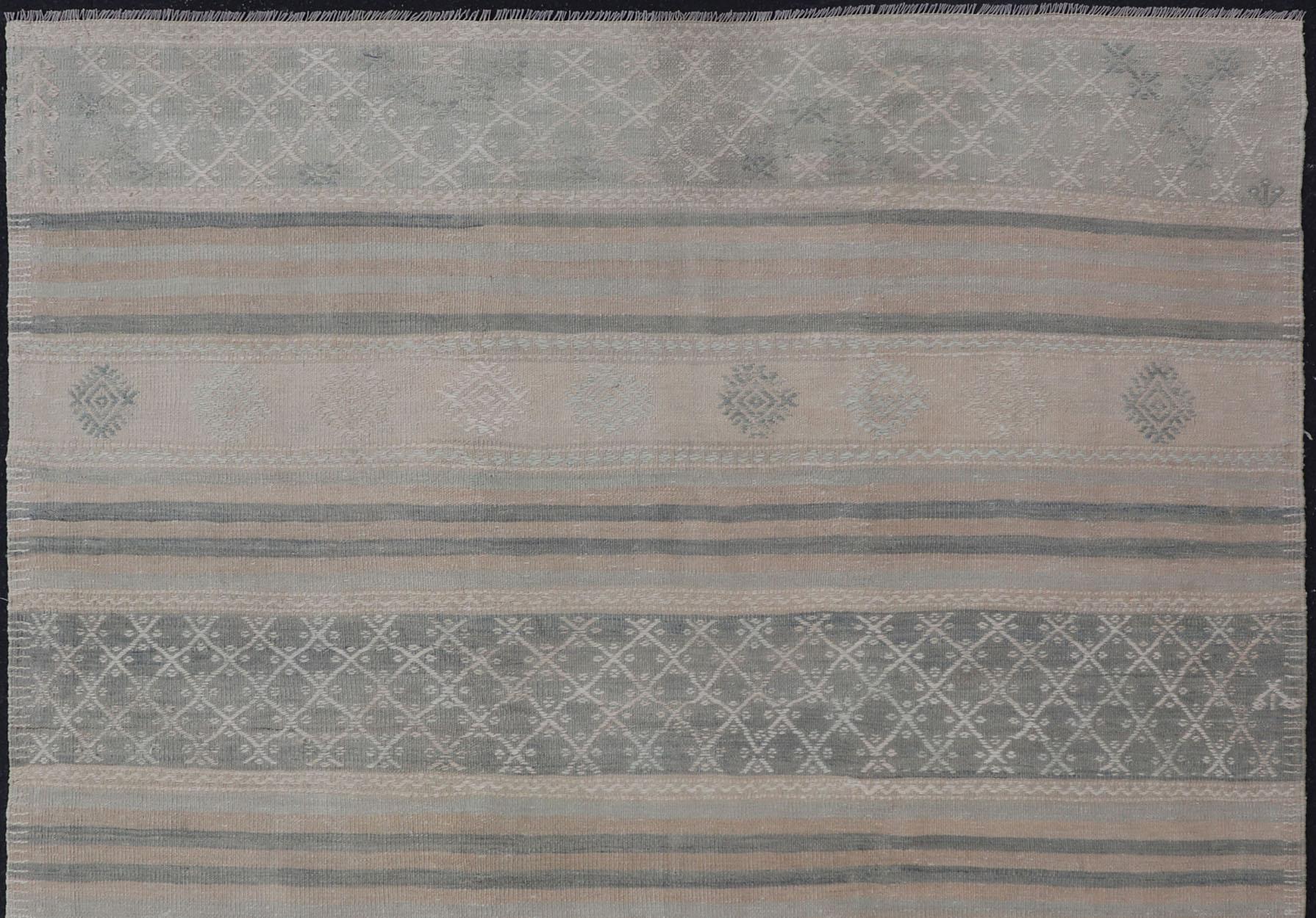 Hand-Woven Muted Vintage Turkish Kilim Rug with Horizontal Stripes & Tribal Motifs For Sale