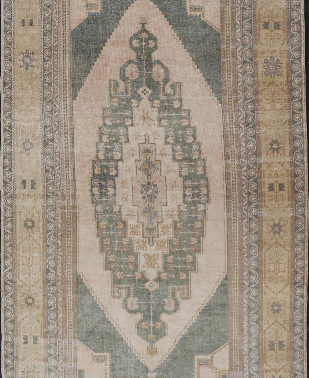 20th Century Muted Vintage Turkish Oushak in Wool with Sub-Geometric Medallion Design
