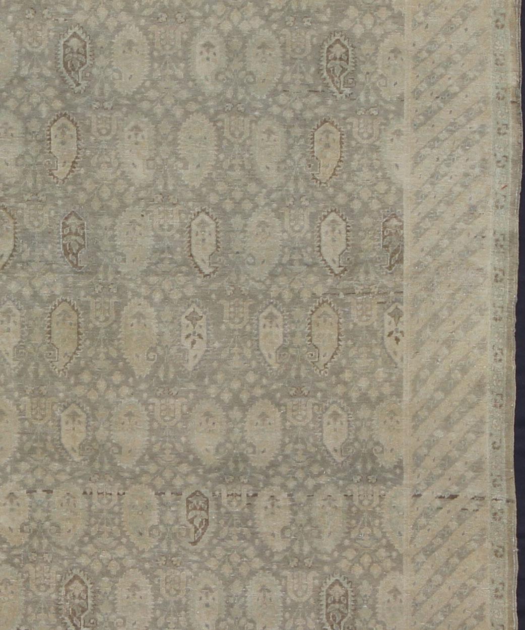 Measures: 6'8'' x 9'0''

Stylized paisley motifs are featured in a repeating pattern on this Sivas wool rug. A blend of Persian inspiration and Turkish design creates a unique, dynamic aesthetic in this while its taupe, gray, camel and gray-green