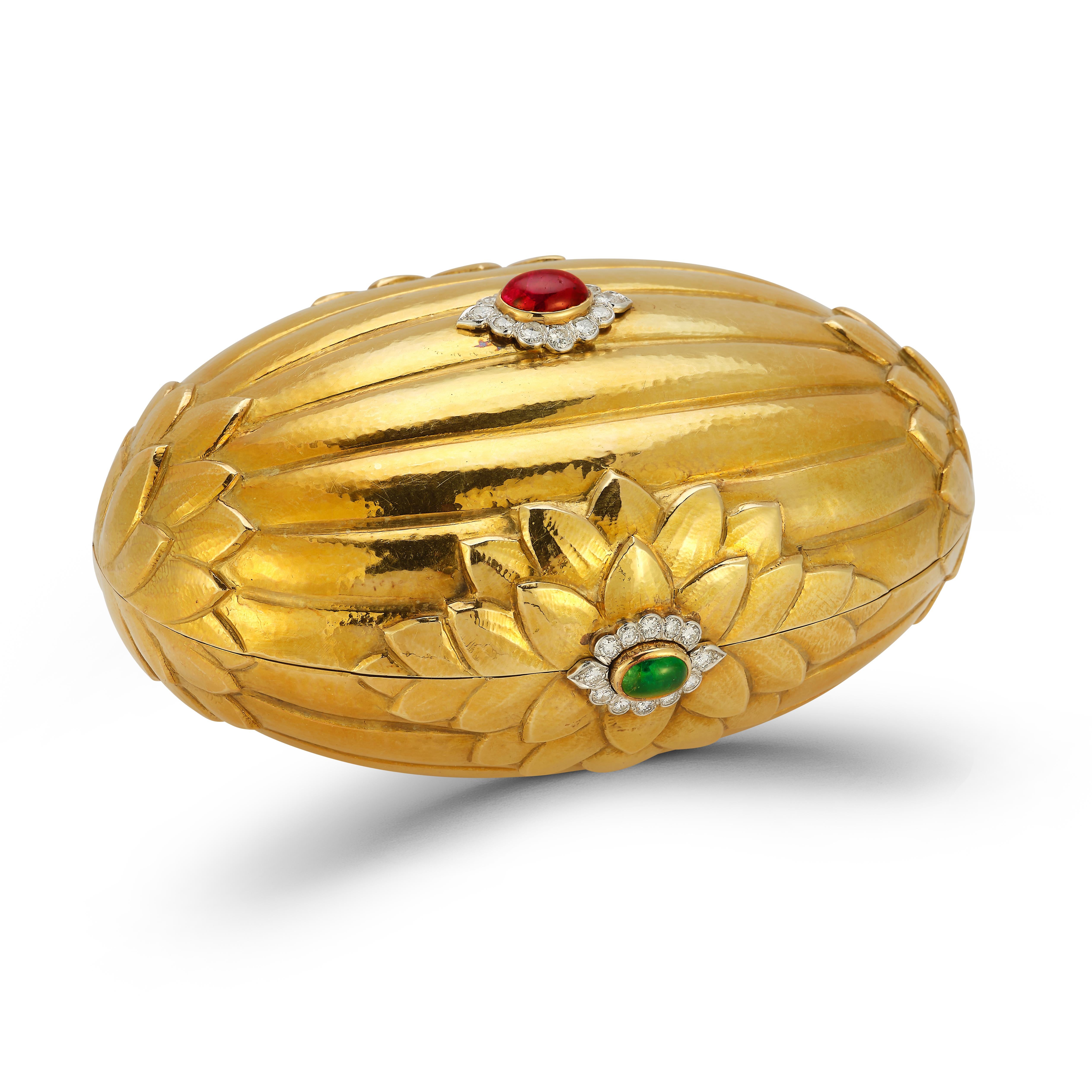 Mutli Gem Gold Clutch by David Webb

The fluted gold clutch with foliate gold accents, set with ruby and emerald cabochons, surrounded by round diamonds, opening to reveal a mirror.

Diamonds weighing a total of approximately 2.70 carats

Diamonds