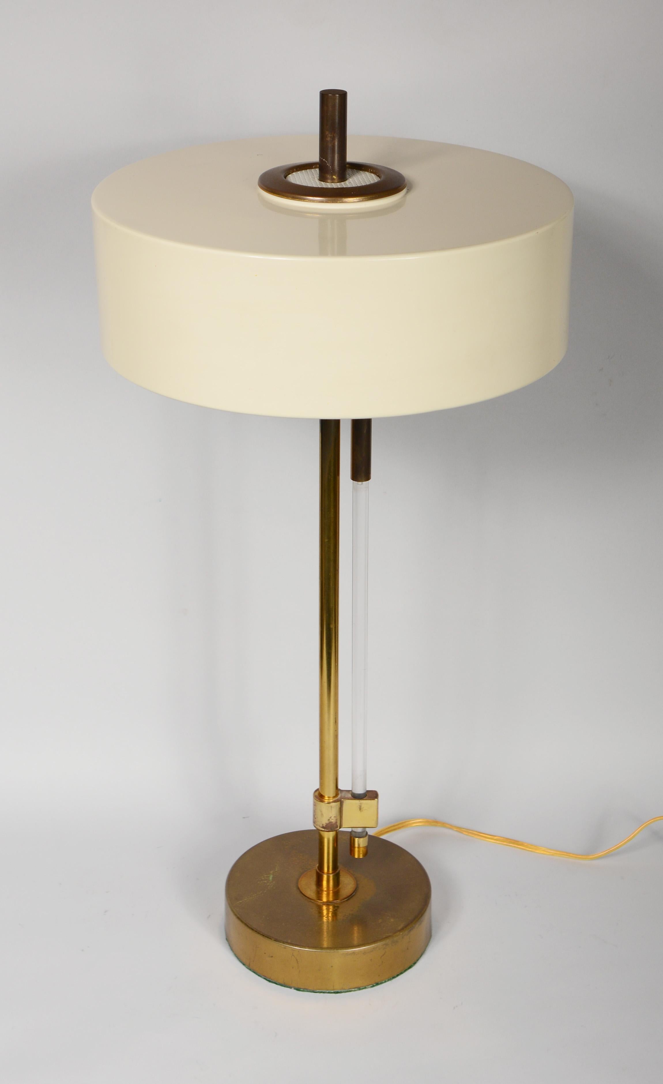 Desk or table lamp by the Mutual Sunset Lamp Company. The switch on this lamp is operated by pulling the acrylic rod down that runs along the brass column. There is a three way switch lighting one bulb, two bulbs and then all three bulbs. The
