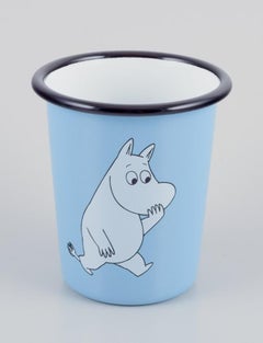 Muurla, Finland. Three enamel mugs featuring motifs of Moomin trolls.