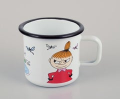 Muurla, Finland. Three enamel mugs with illustrations of Moomins