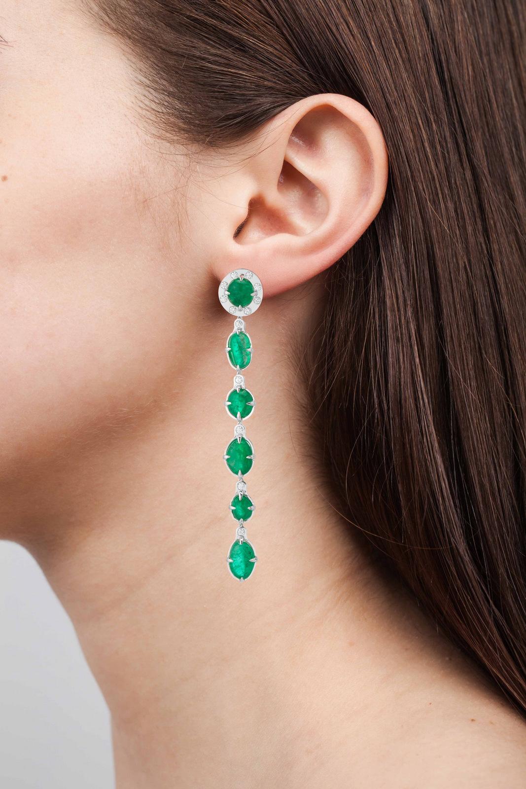 18 Karat classic drop earrings with halo diamonds weighing 0.94 carats and tumbled Muzo Colombian emeralds weighing 35.68 carats.

Muzo Emerald Colombia Heritage Muisca Earrings set with 35.68 carats Emerald.

Named in honor of the ancient