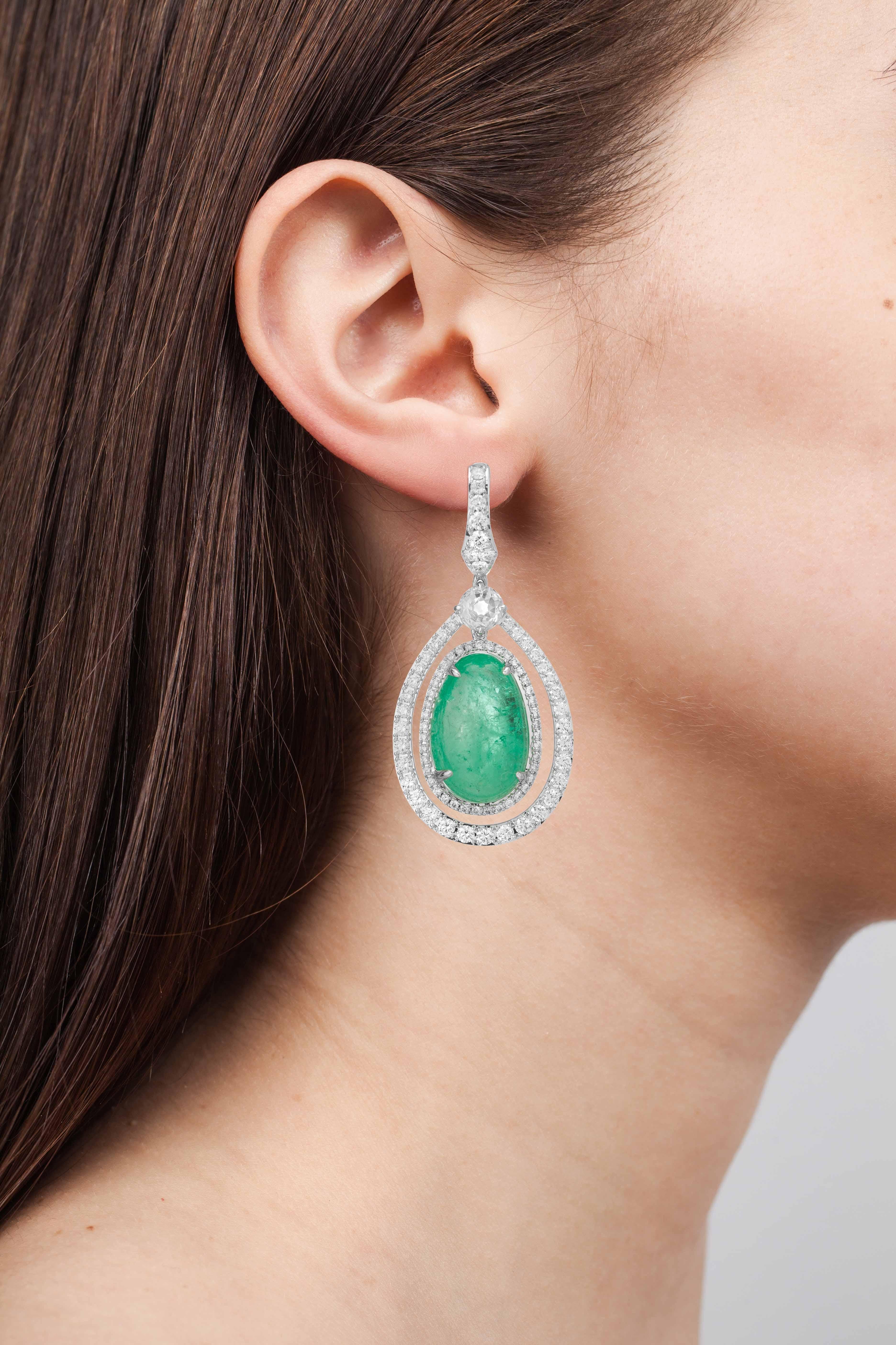 18 Karat white gold statement earrings set with 37.99 carats of Muzo Colombian emeralds and a single halo of round brilliant diamonds weighing 4.8 carats.

Muzo Emerald Colombia Heritage Verity Earrings set with 37.99 carats Emerald

Verity is a