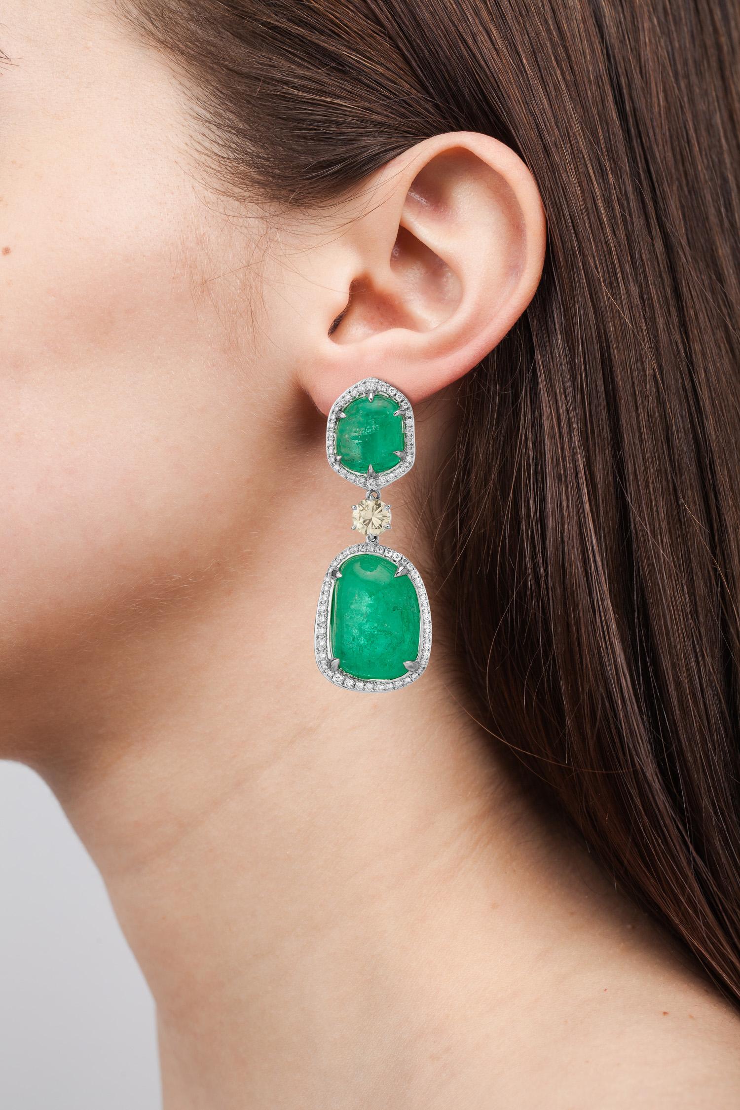 18 Karat white gold dangle earrings set with organic tumbled Muzo emeralds of 67.91 carats surrounded by 2.79 carats of round brilliant diamond pave.

Muzo Emerald Colombia Heritage Verity Earrings set with 67.91 carats Emerald.

Verity is a tribute