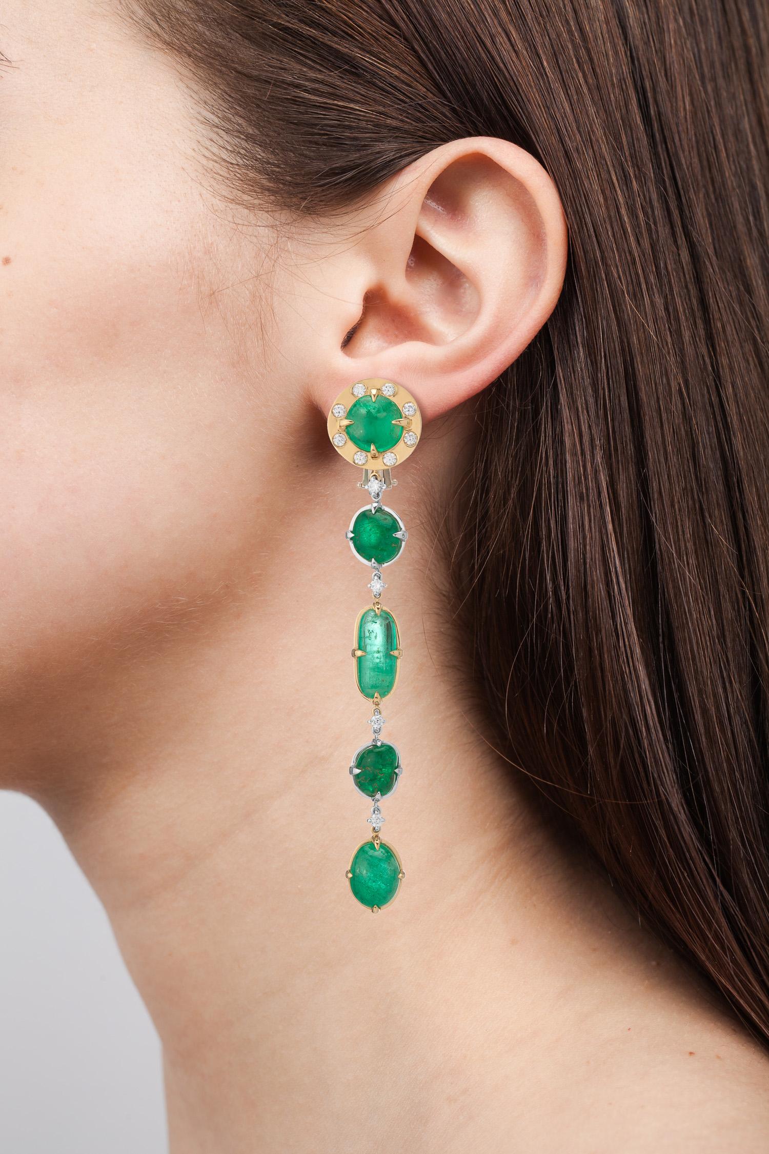 18 Karat yellow and white gold long drop earrings featuring different shapes of Muzo Colombian emeralds weighing 34.85 carats and gypsy set diamonds weighing 0.81 carats. 

Muzo Emerald Colombia Heritage Muisca Earrings set with 34.85 carats