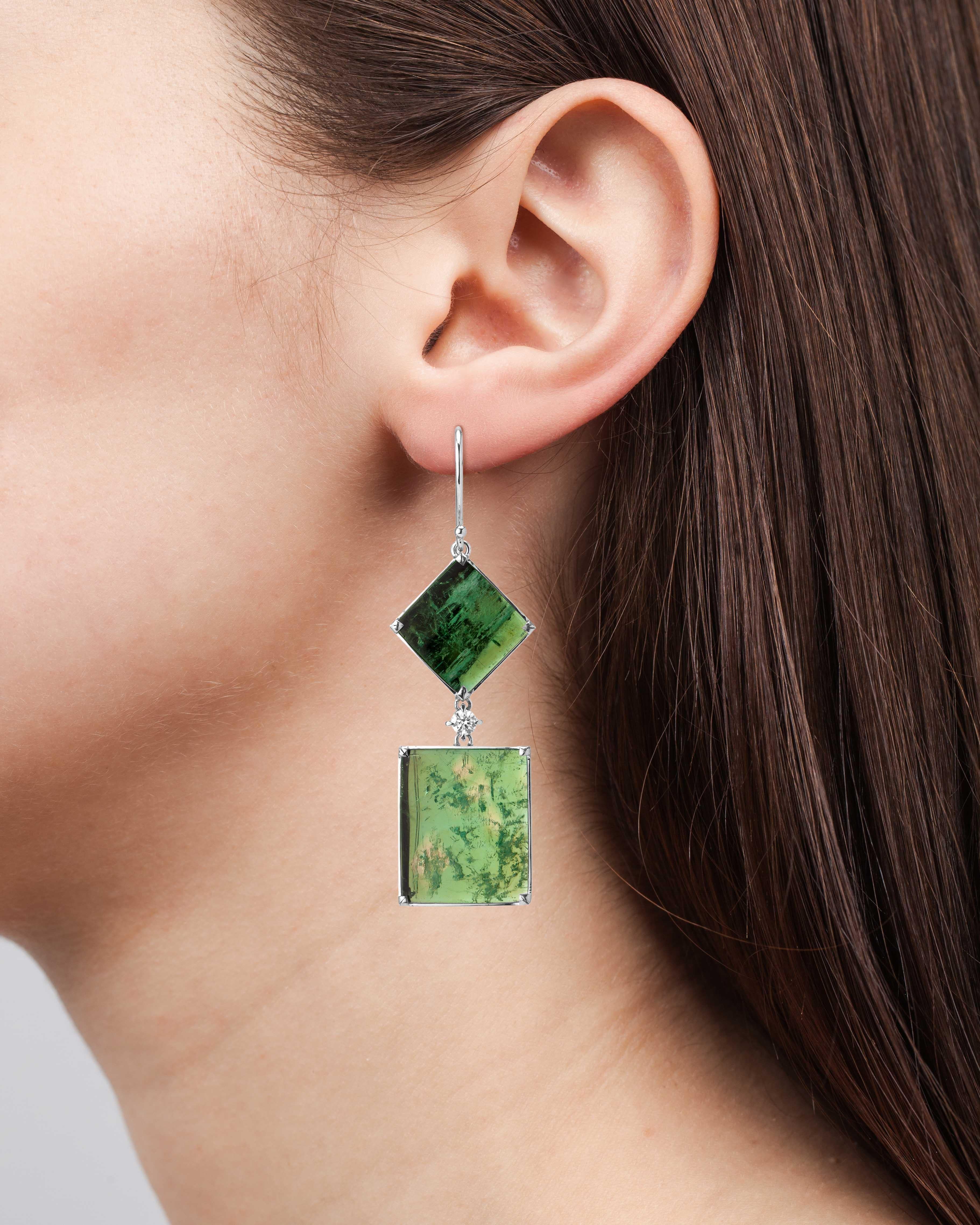 One of a kind white gold art deco style earrings set with Muzo Colombian emerald slices weighing 21.72 carats and accented with 0.30 carats.

Muzo Emerald Colombia Heritage Atocha Earrings set with 21.72 carats Emerald.

Atocha is inspired by a