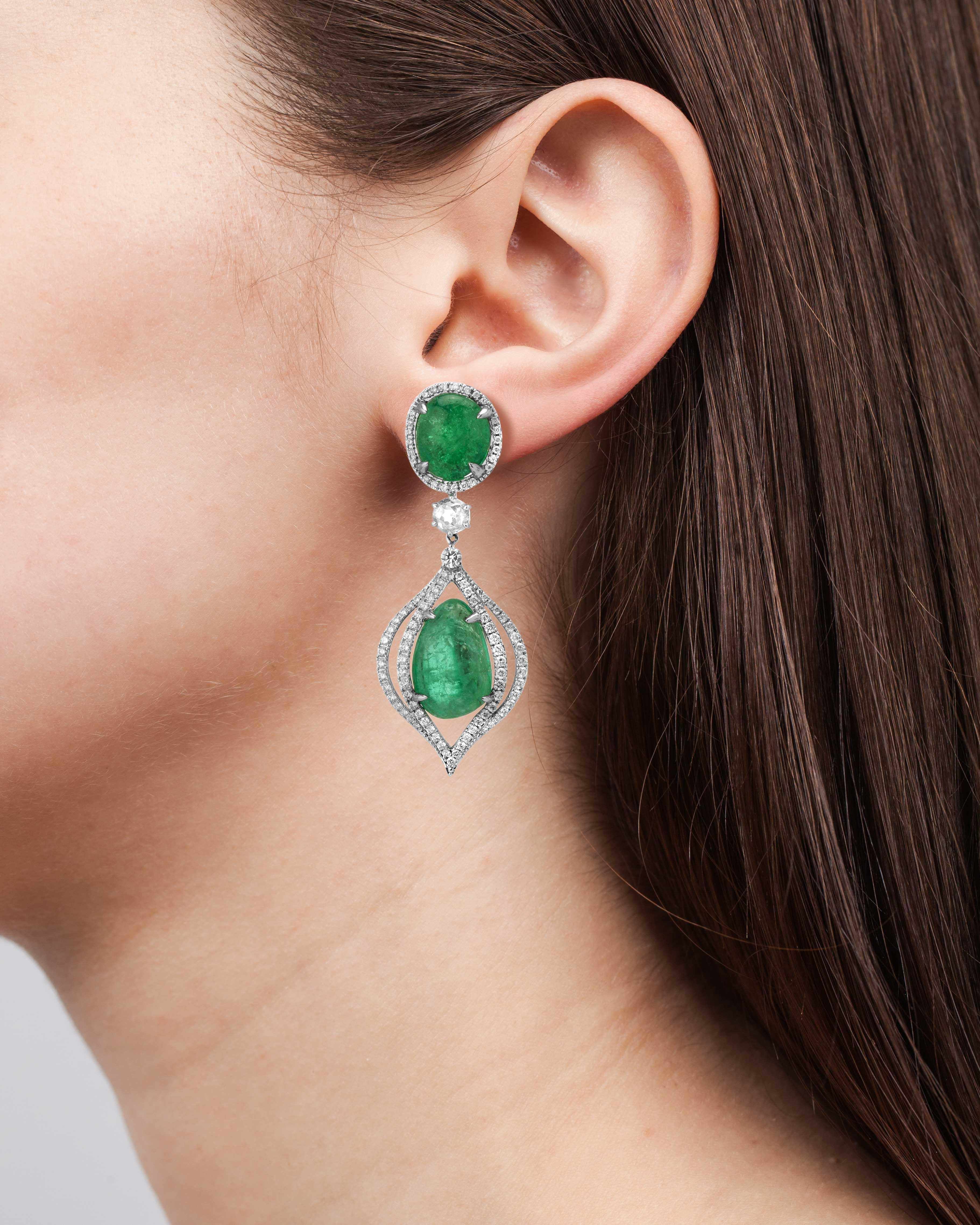 18 Karat white gold dangle earrings set with organic tumbled Muzo emeralds of 36.56 carats and 2.81 carats of round brilliant diamond pave.

Muzo Emerald Colombia Heritage Verity Earrings set with 36.56 carats Emerald.

Verity is a tribute to the