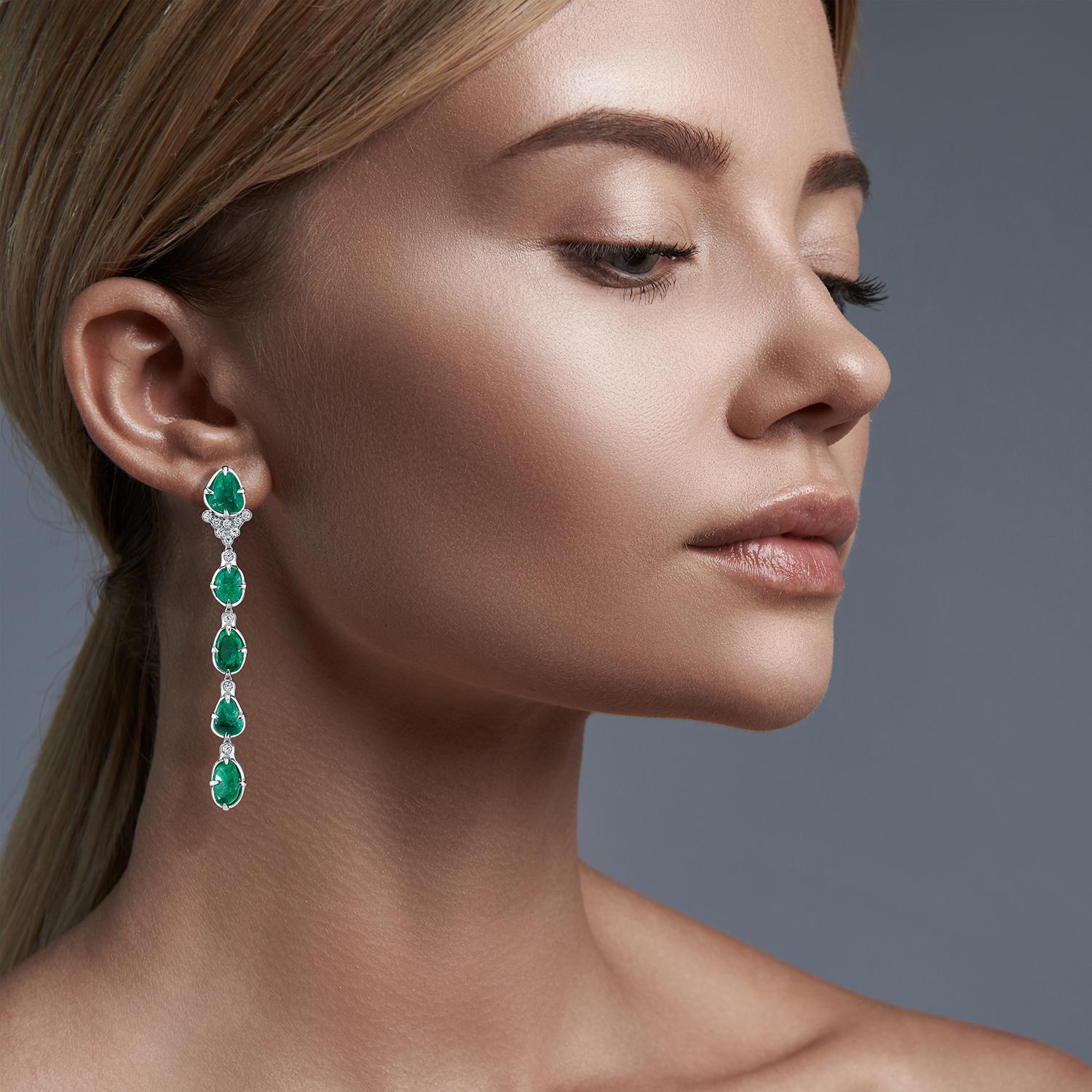 18 Karat white gold long drop claw setting earrings featuring Muzo Colombian emeralds weighing 27.39 carats and diamonds weighing 0.86 carats.

Muzo Emerald Colombia Heritage Muisca Earrings set with 27.39 carats Emerald.

Named in honor of the