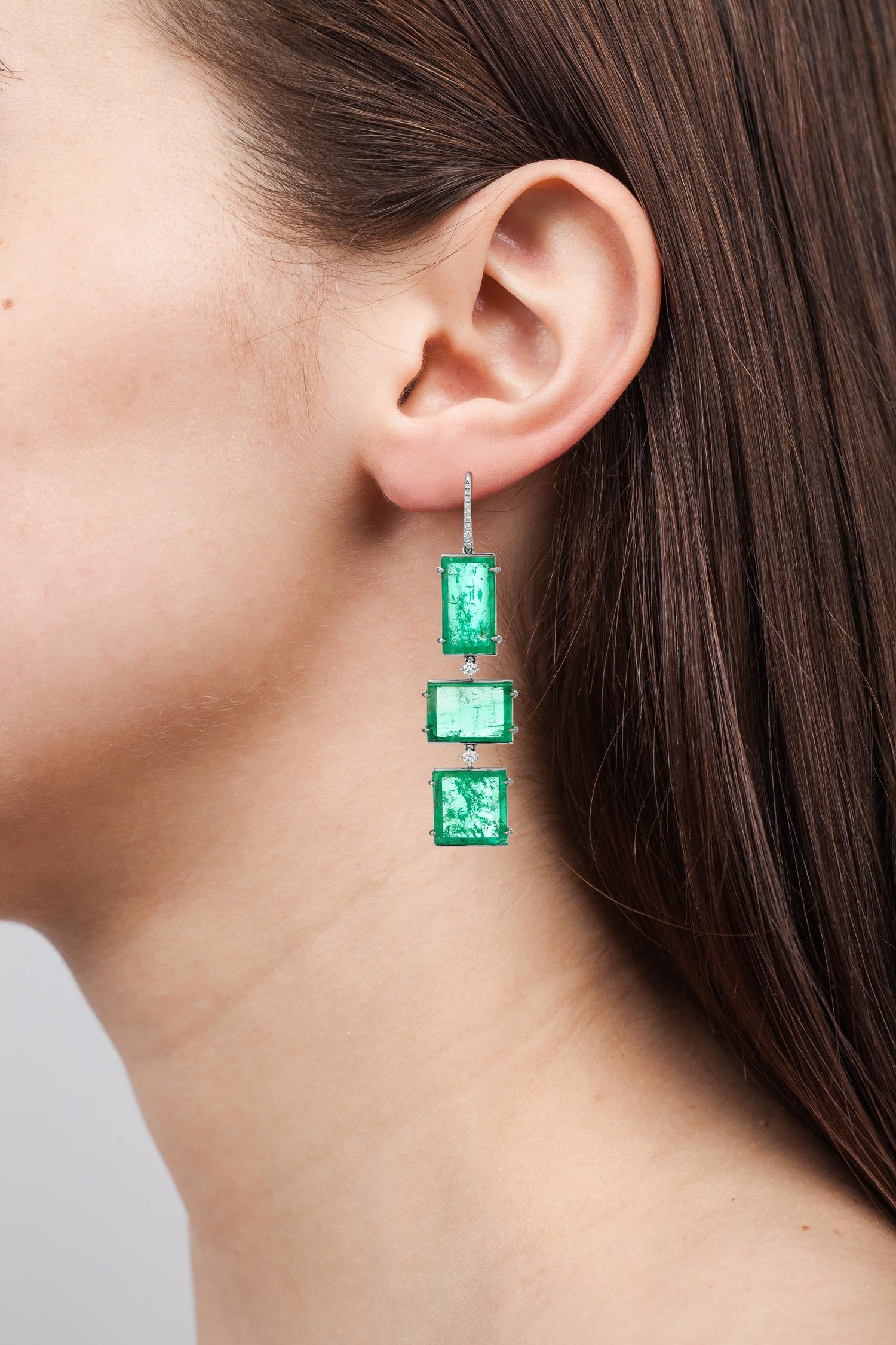 One of a kind Art Deco Style drop earrings featuring 34.86 carats of Muzo Colombian emeralds and diamonds weighing 0.37 carats.

Muzo Emerald Colombia Heritage Atocha Earrings set with 34.86 carats Emerald.

Atocha is inspired by a collection of