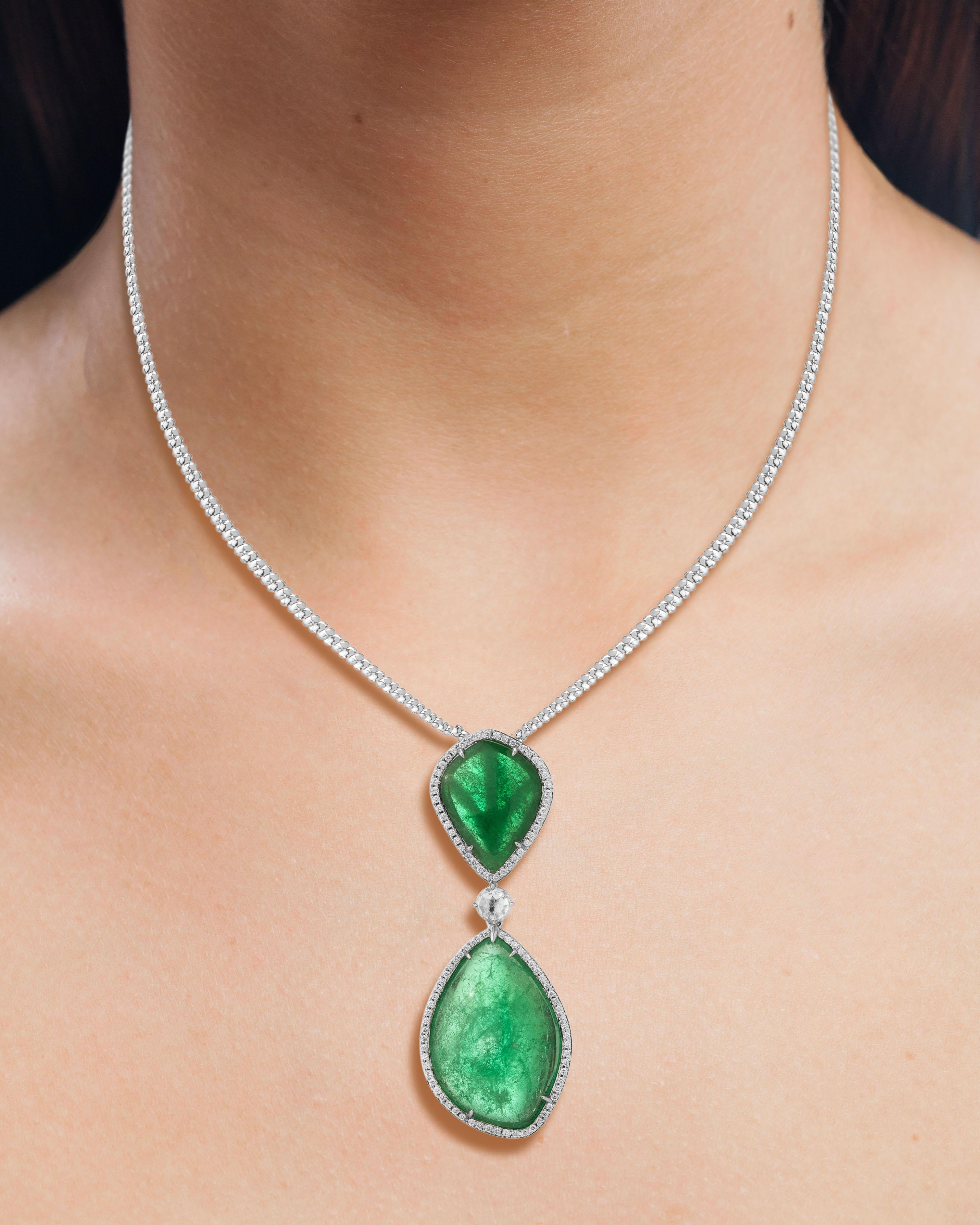 Classic 18 Karat white gold pendant set with organic Muzo Colombian emeralds weighing 31.30 carats and accented by a halo of round brilliant diamonds weighing 1.14 carats.

Muzo Emerald Colombia Heritage Atocha Necklace set with 31.30 carats