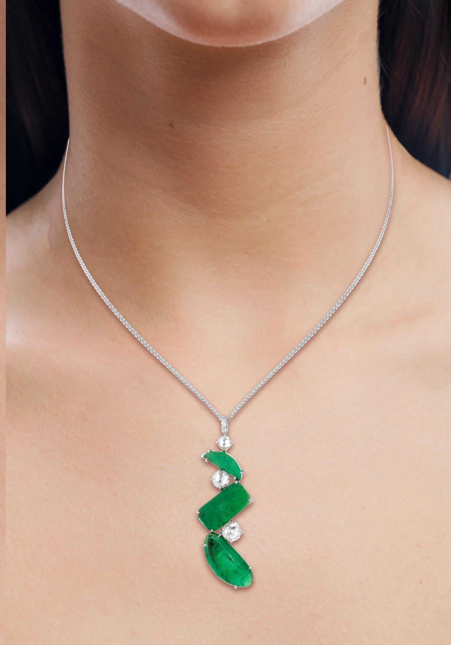 Modern 18 Karat white gold pendant set with mixed shape slices weighing 13.02 carats of Muzo Colombian emeralds and 1.72 carats of diamonds.

Muzo Emerald Colombia Heritage Atocha Necklace set with 13.02 carats Emerald.

Atocha is inspired by a