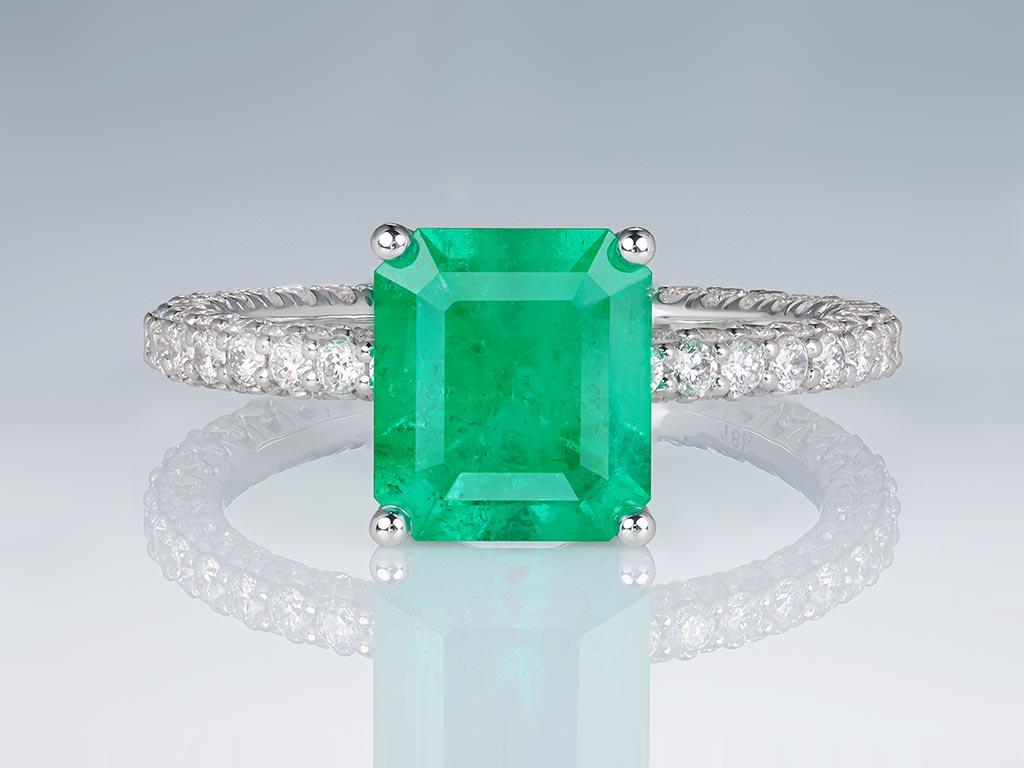 The 2.191 carat Muzo Green Colombian Emerald has a stylish emerald-cut shape, and its rich hue gives the stone a special, unique look. 

Surrounding the mesmerizing emerald are 112 brilliant-cut diamonds, each a testament to the highest standards of