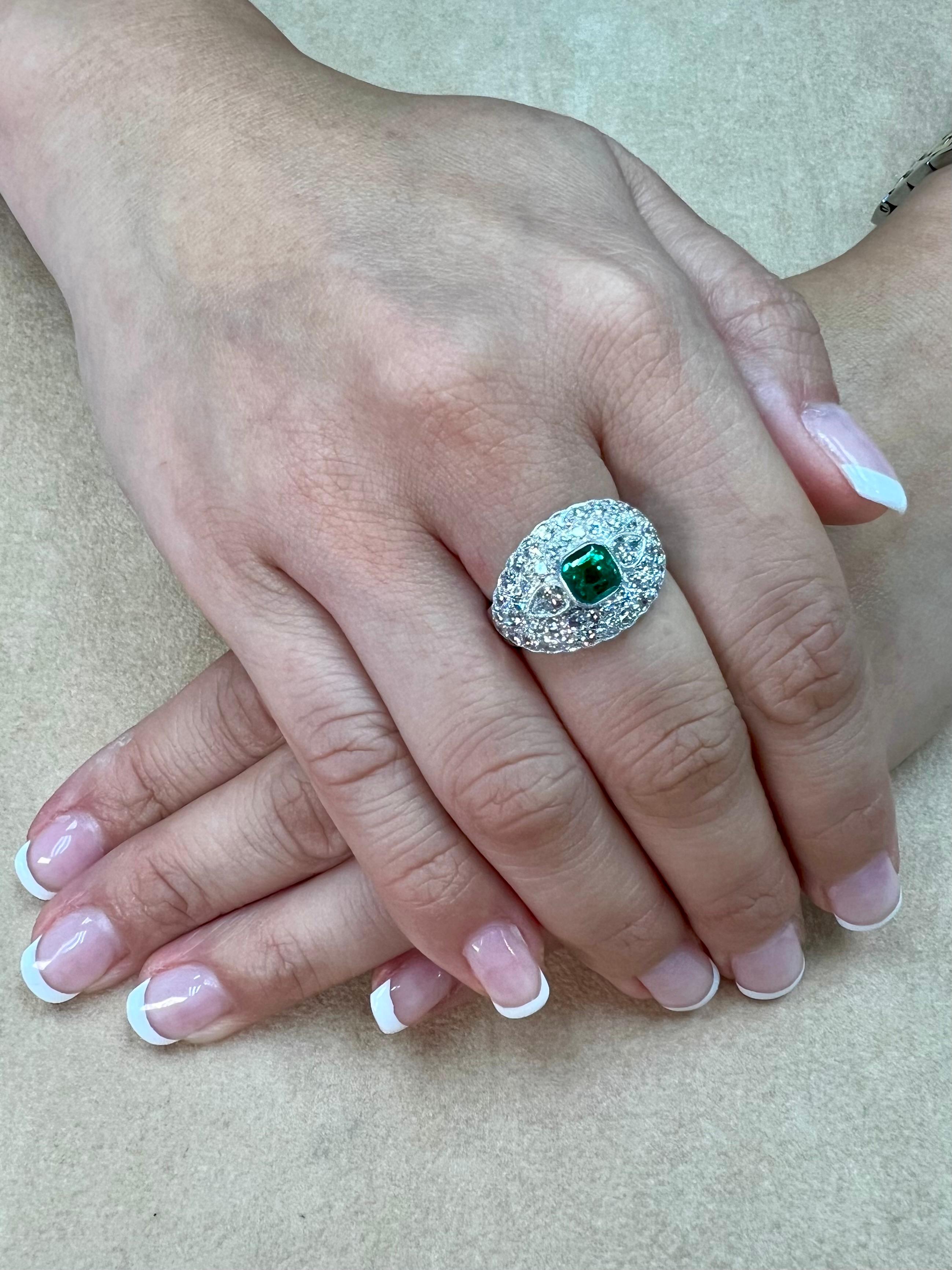 Please check out the HD video! This ring looks much much better in person and clean in emerald standards! This center emerald is around 0.78cts. This emerald has the correct vivid green that is in high demand. The ring is not backed, so the emerald