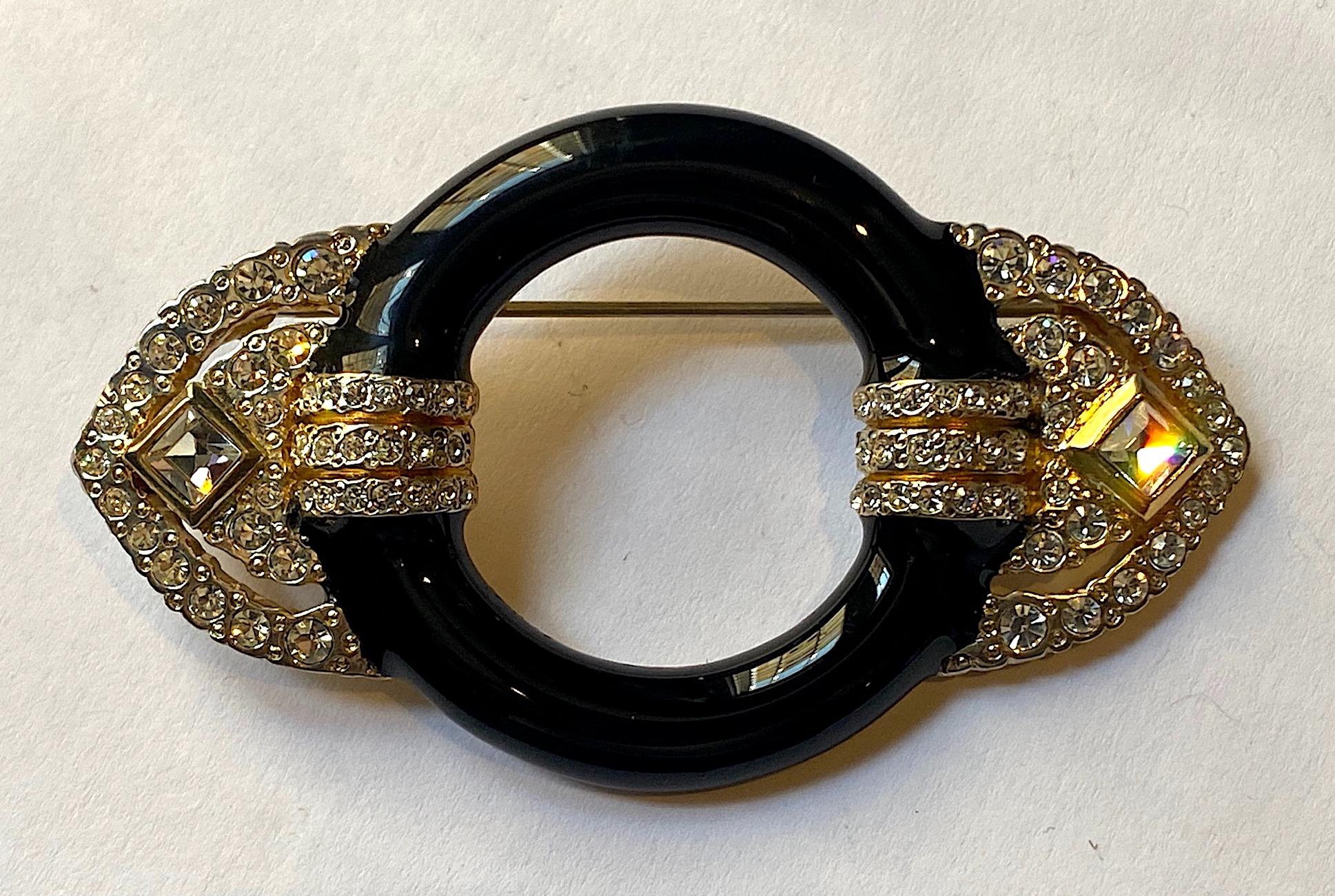 A beautiful crafted Art Deco style brooch by by Italian company MV Vellano. Made in the 1980s during the popular revival of the Art Deco style in Fashion and Interiors the brooch is gold plated with black enamel and hand set with round and square