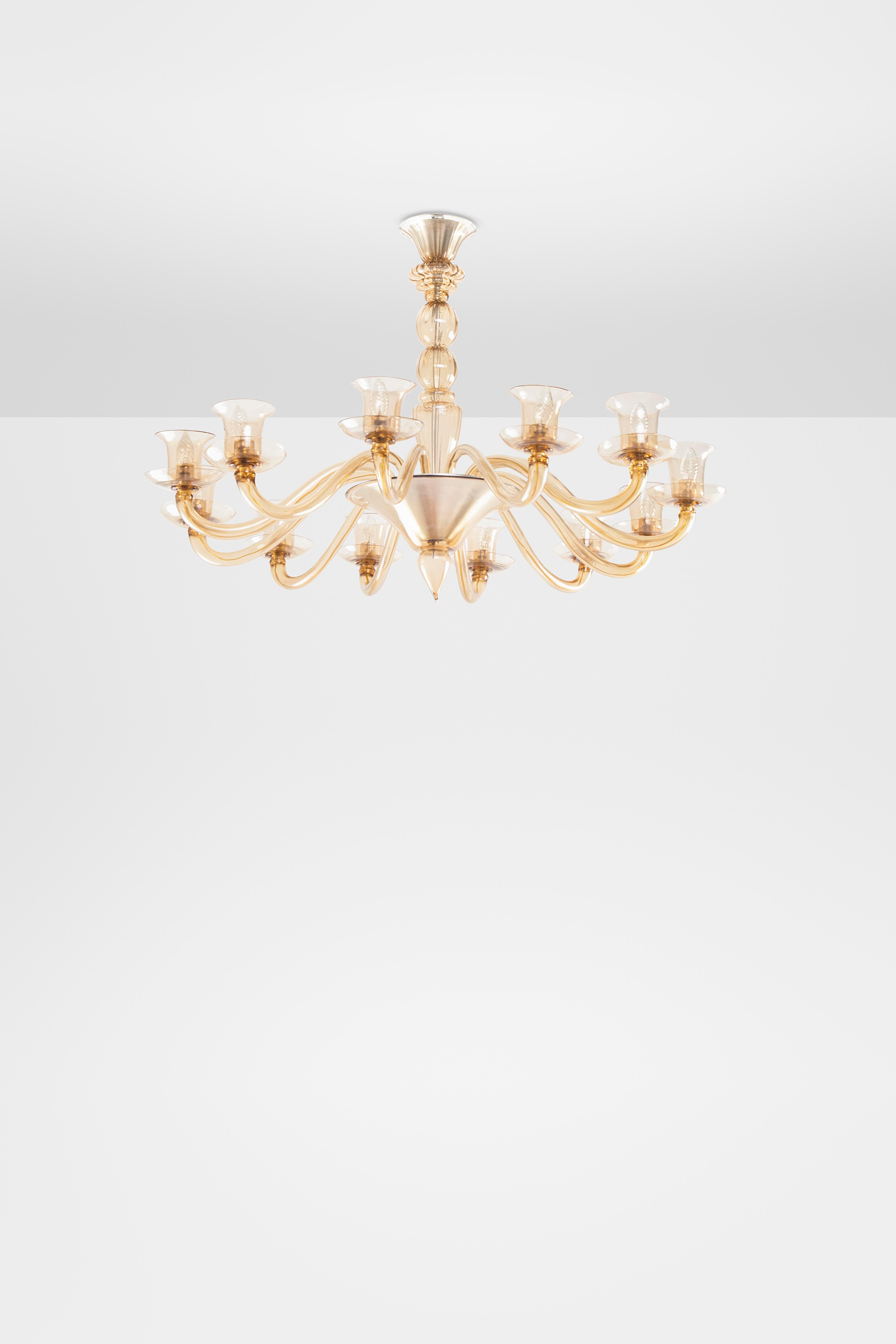 This splendid chandelier from the 1920s is in straw-colored or dark amber colored Murano blown glass. The design is by the MVM Cappellin company which will then merge into Venini and so the chandelier will therefore be a model also taken up by