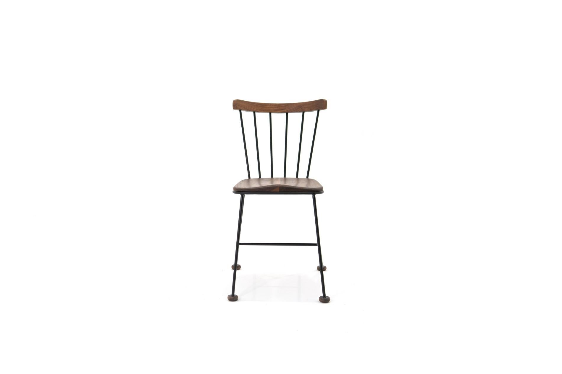 A retro-style chair featuring an ergonomic shaped wooden seat in-cased in a hand-bent steel frame with solid wood backrest. It works as a dining chair, office chair, or side chair. 

This handcrafted piece is hand-oiled using our in-house oils and