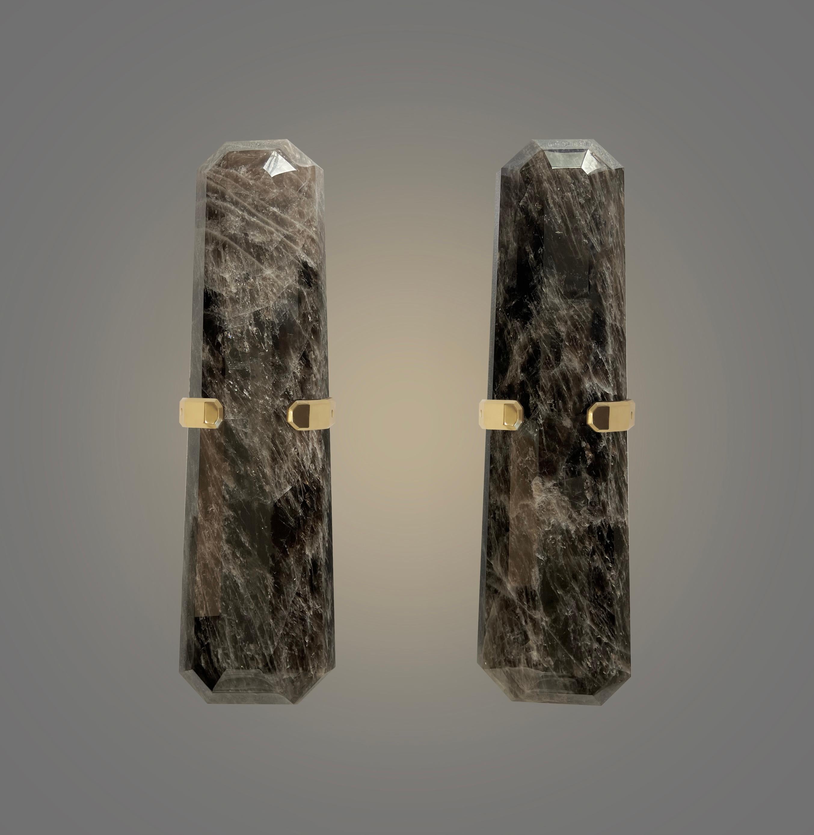 Pair of finely carved multifaceted smoky rock crystal sconces with polished brass decorations. two sockets installed.160w total.

recommend jbox 2in x4in
Custom size and metal finish upon request.
