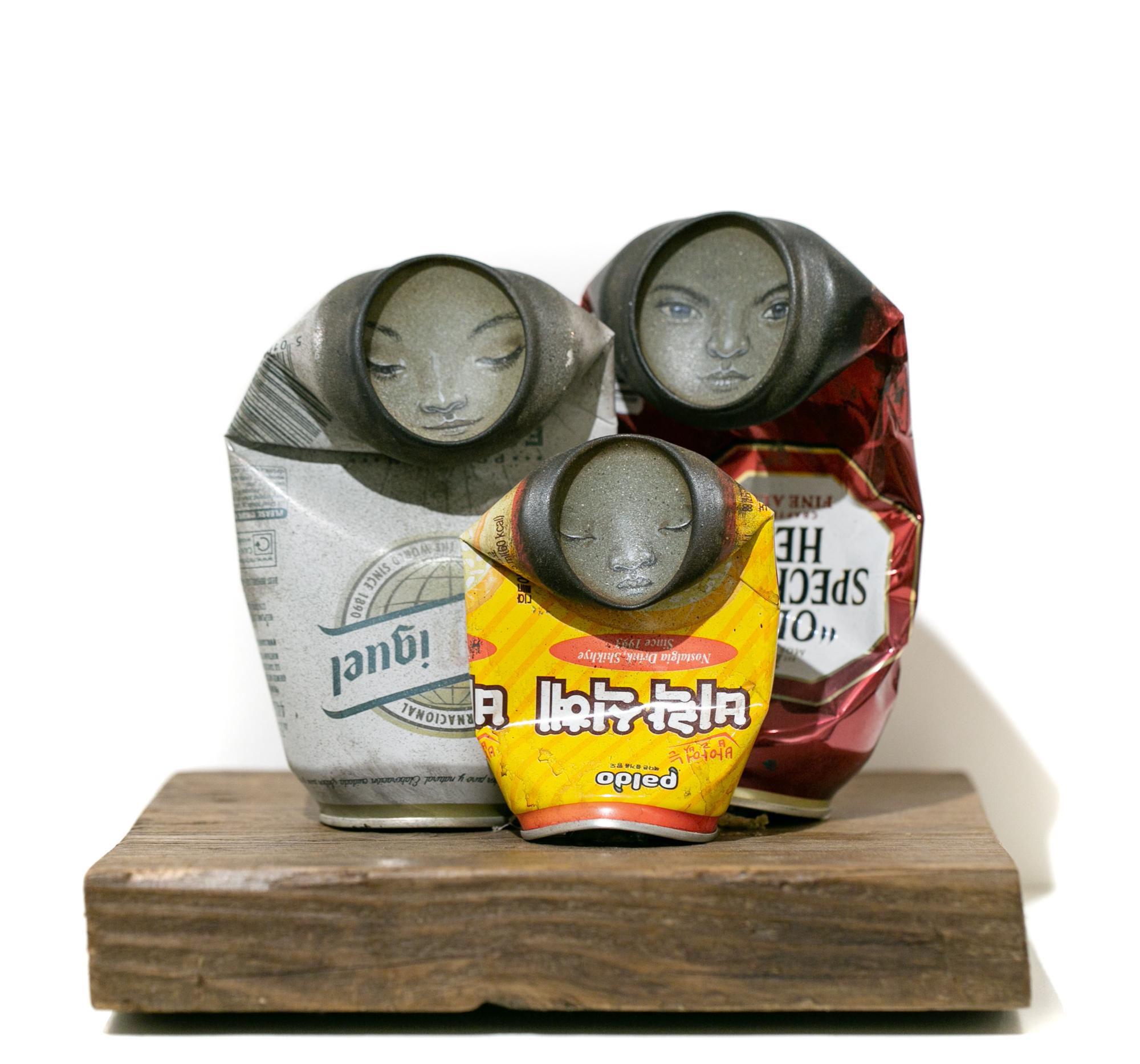 My Dog Sighs Figurative Sculpture - "Family", Folded Can Freestanding Sculpture, Painted faces, Found objects