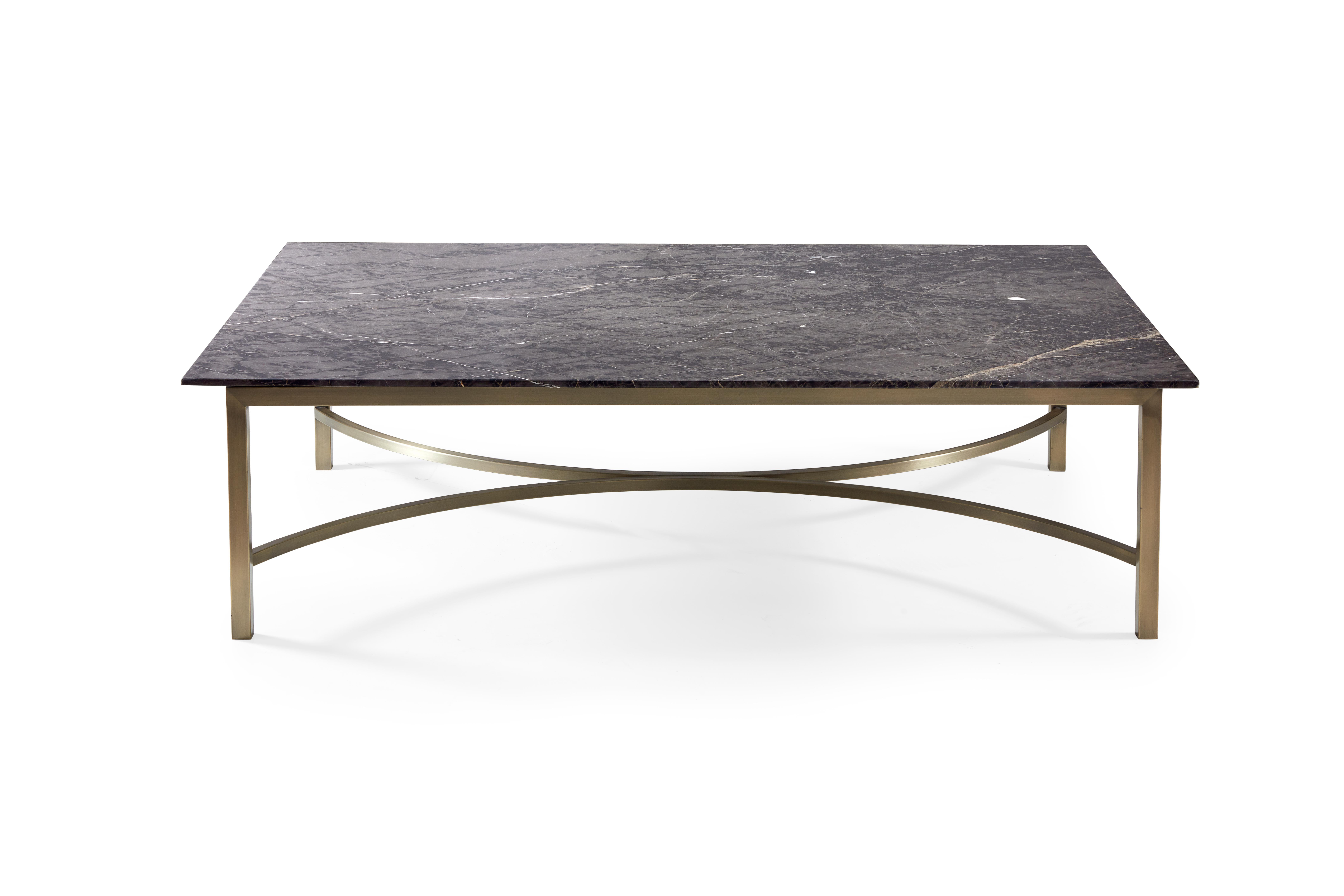 A black and white veined marble top upon bronze base, this coffee table is meant to be a central focus in any living space. Style the top with books and accessories, or leave it bare to admire the natural beauty.