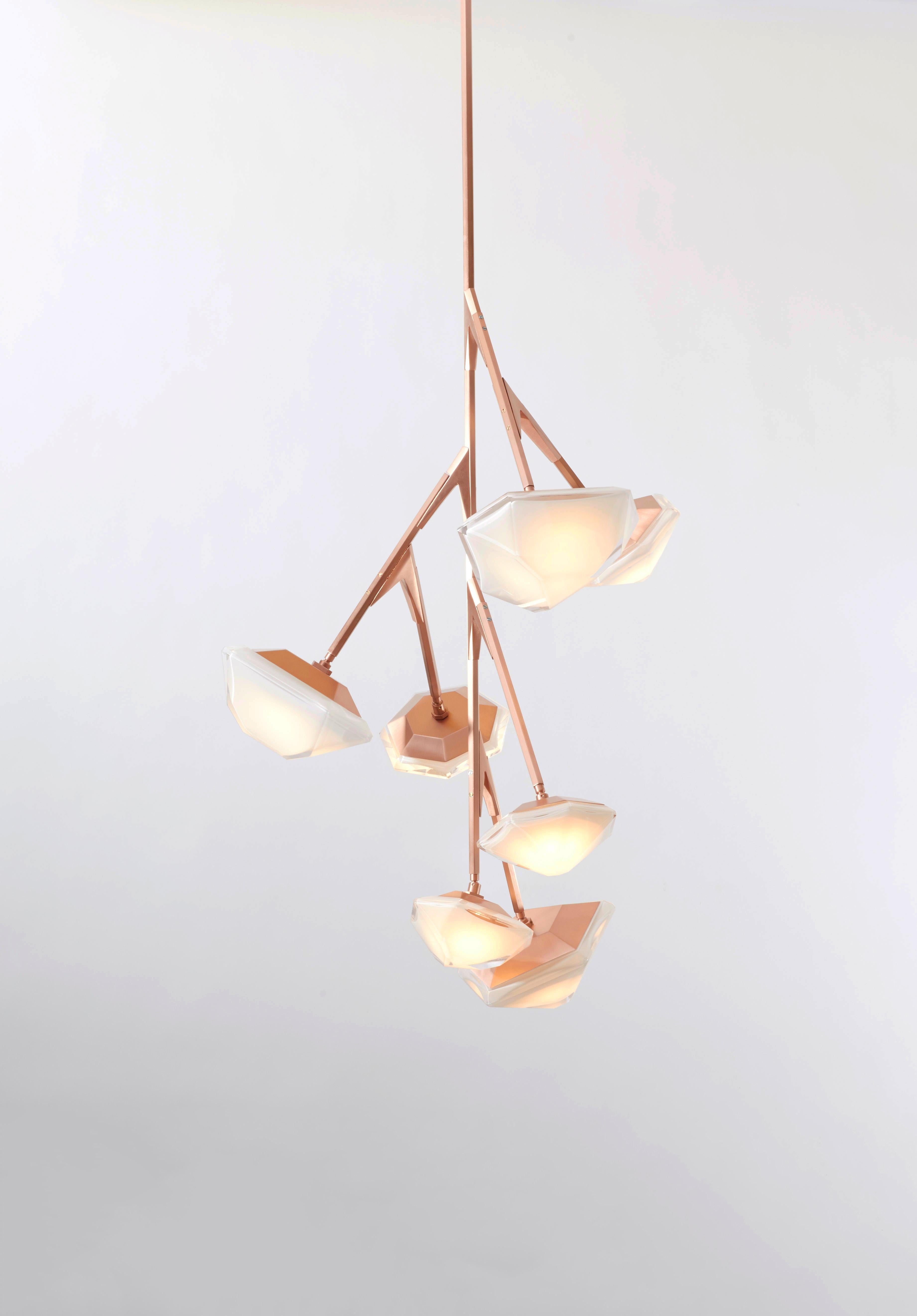 Myriad tall chandelier is inspired by nature’s bioluminescent organisms, made up of the brand’s signature double-blown glass and satin metallic hardware. Its articulated stems carry the soft-lit pivoting heads to create a delicate, asymmetric and