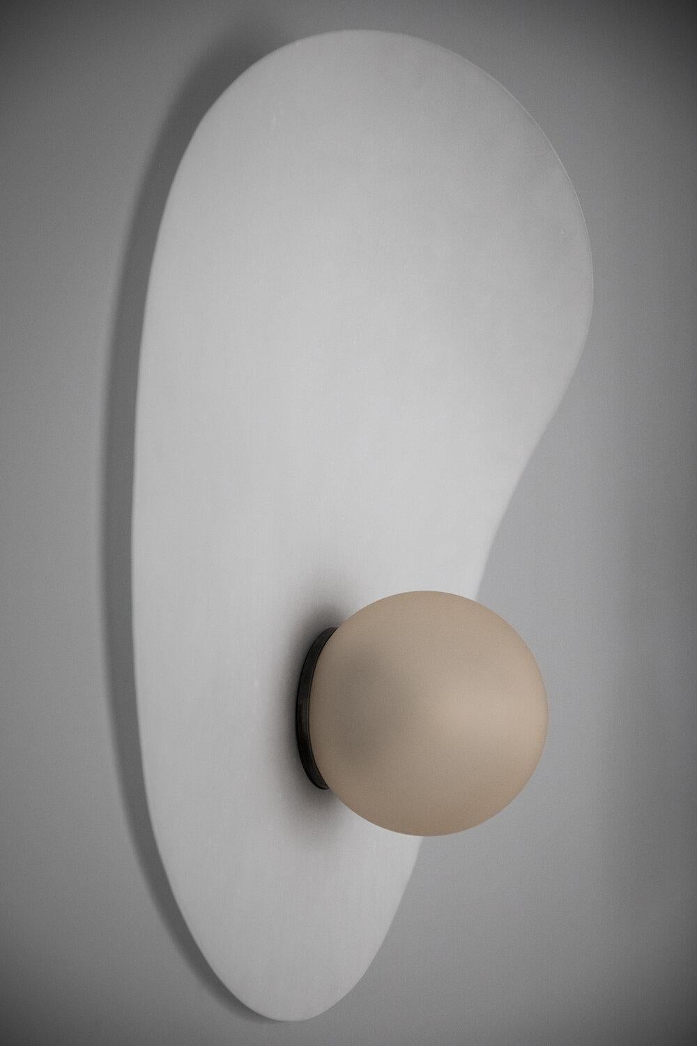 Myrna sconce light by Ladies & Gentlemen Studio
Dimensions: 23” x 18”, 6” globe
Materials: Powder-coated steel (also available in brass), fabric cord, color washed acid etched glass globe. 
Shade Options: Perforated Smoke, Perforated Fog,