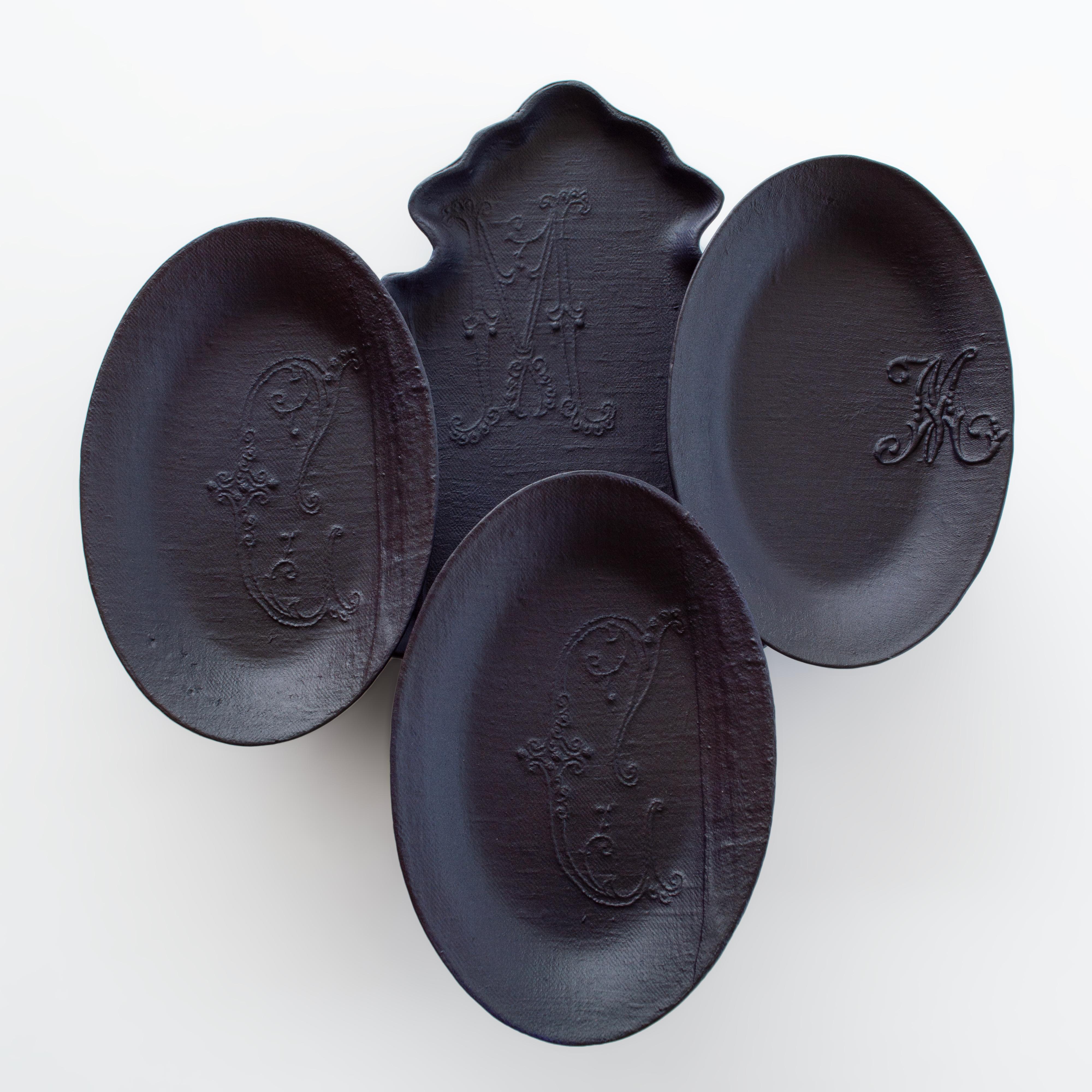This installation consists of a group of hand made plates in porcelain with our signature fabric texture combined with heritage shapes.

The title Myrtille et Cassis (blueberry and blackcurrant in French) references the letters M and C embroidery on
