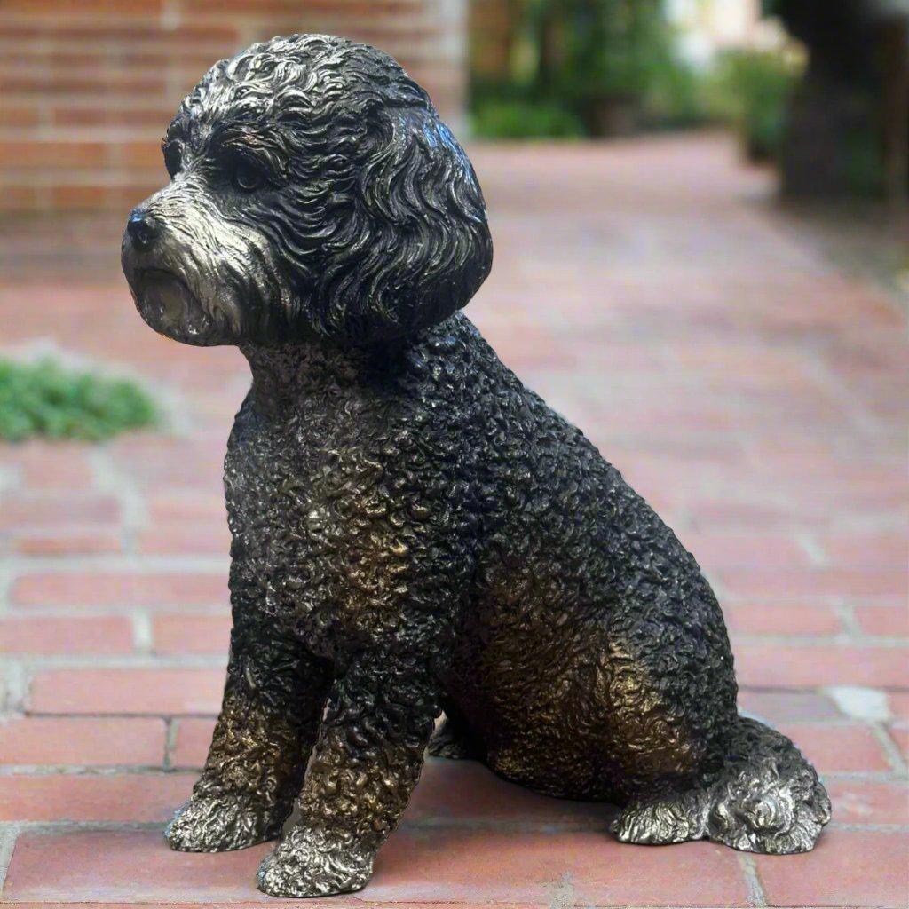 This charming bronze dog statue of a Bernedoodle captures the unique qualities that make this breed so beloved. The dog sculpture features intricate detailing in the dog’s curly, textured fur, bringing out the distinct blend of the Bernese Mountain