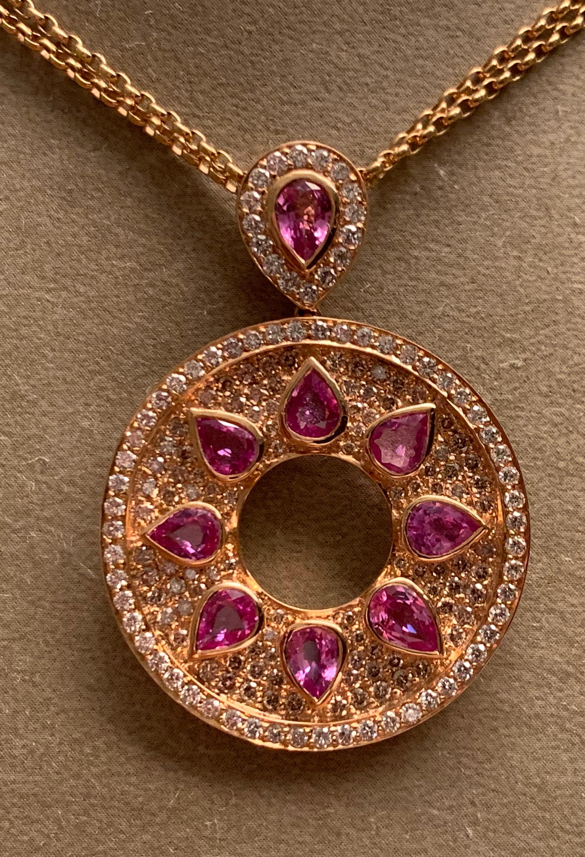 This fabulous 18k pink Gold pendant is set with 167 sparkling brown and white round brilliant cut diamonds that weigh 1.98 ct. The diamonds are accentuated by 9 lovely pear shape pink sapphires that weigh3.31 ct. The pendant, wich is detachable, 