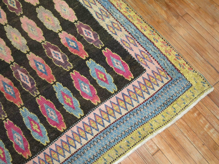 A unique one of a kind Boutique looking vintage rug in bright colors. We have examined this rug thoroughly and we can’t figure out where it was actually made and when it was made. We suspect its either a Persian or Turkish piece. It could have been