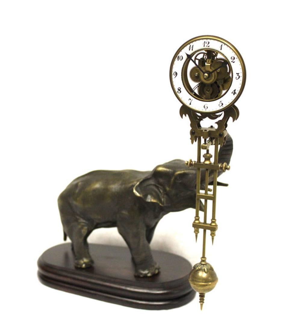 The clock is hanging on a solid Brass cast elephant statue with polished wood base. Time reads from hand painted 2