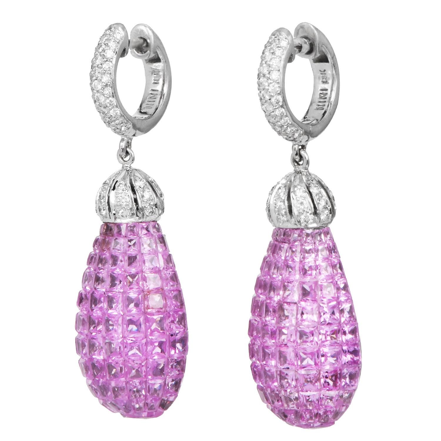 Exquisitely crafted in 18K white gold, these drop earrings showcase precisely cut pink sapphires in a seamless mystery setting. The teardrop-shaped dangle is topped with a diamond-set cap and suspended from a hoop pavé-set with round brilliant