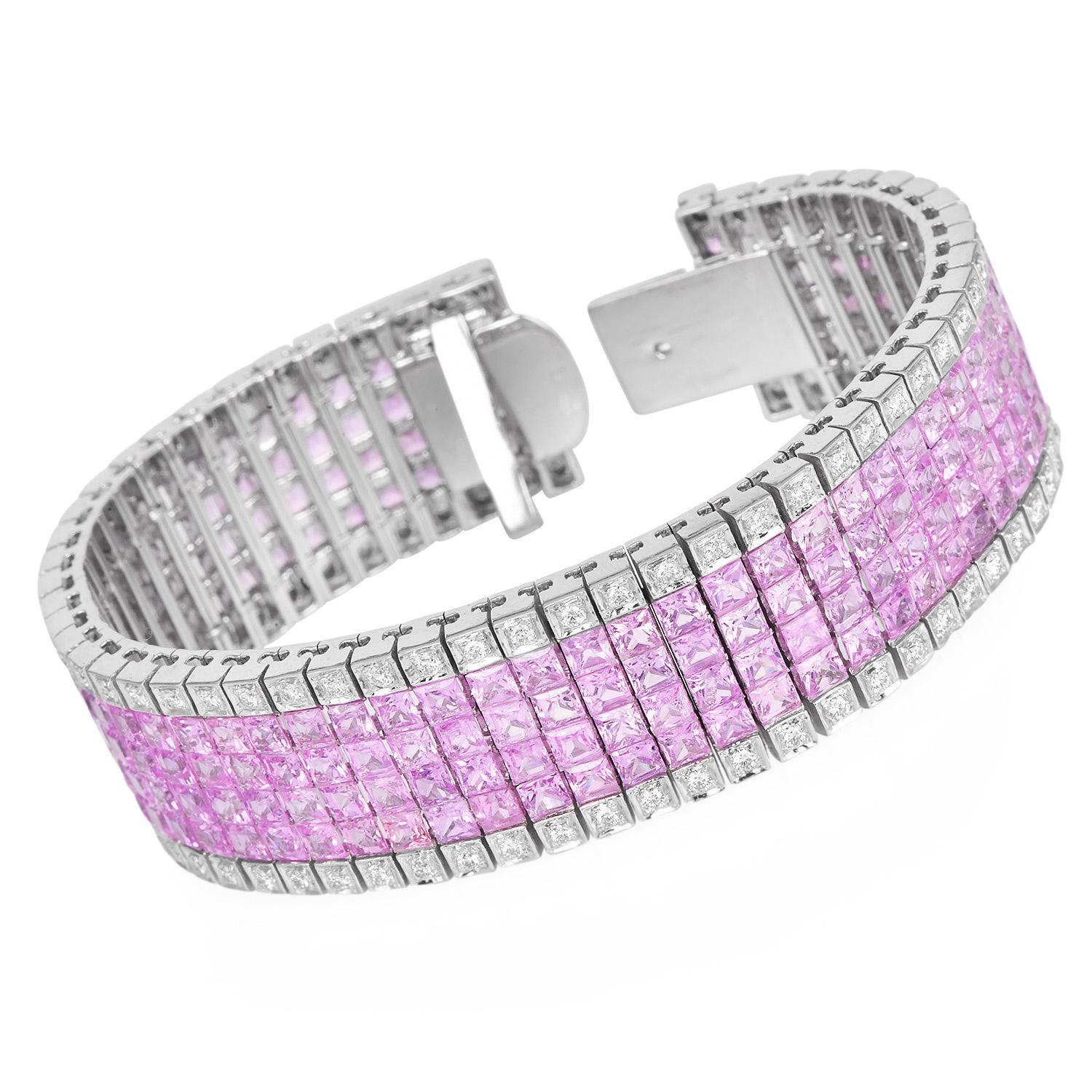 This luxurious wide bracelet features a vibrant display of square-cut natural pink sapphires, precisely set in a multi-row pattern. Crafted in 18K white gold, the bracelet is adorned with round brilliant diamonds that frame the sapphire rows with