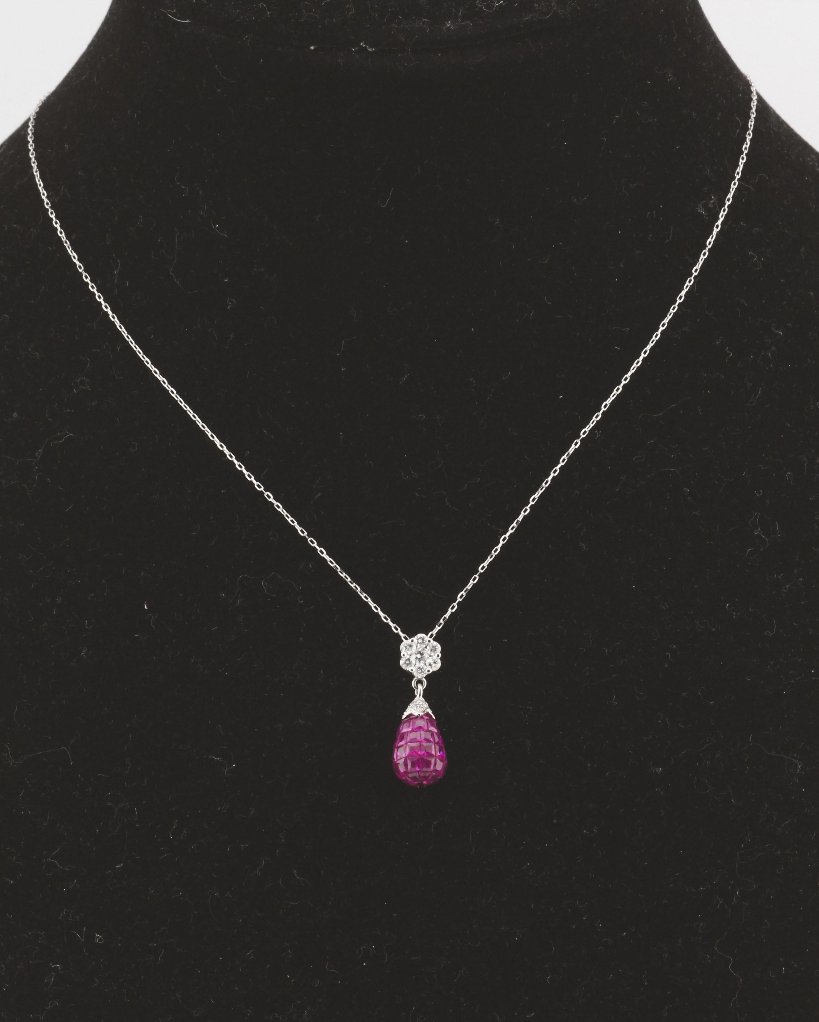 The Mystery Set Ruby Diamond 18K White Gold Pendant Necklace is an exquisite piece of jewelry that showcases both unparalleled craftsmanship and timeless elegance. This luxurious necklace features a stunning diamond flower pendant, from which a