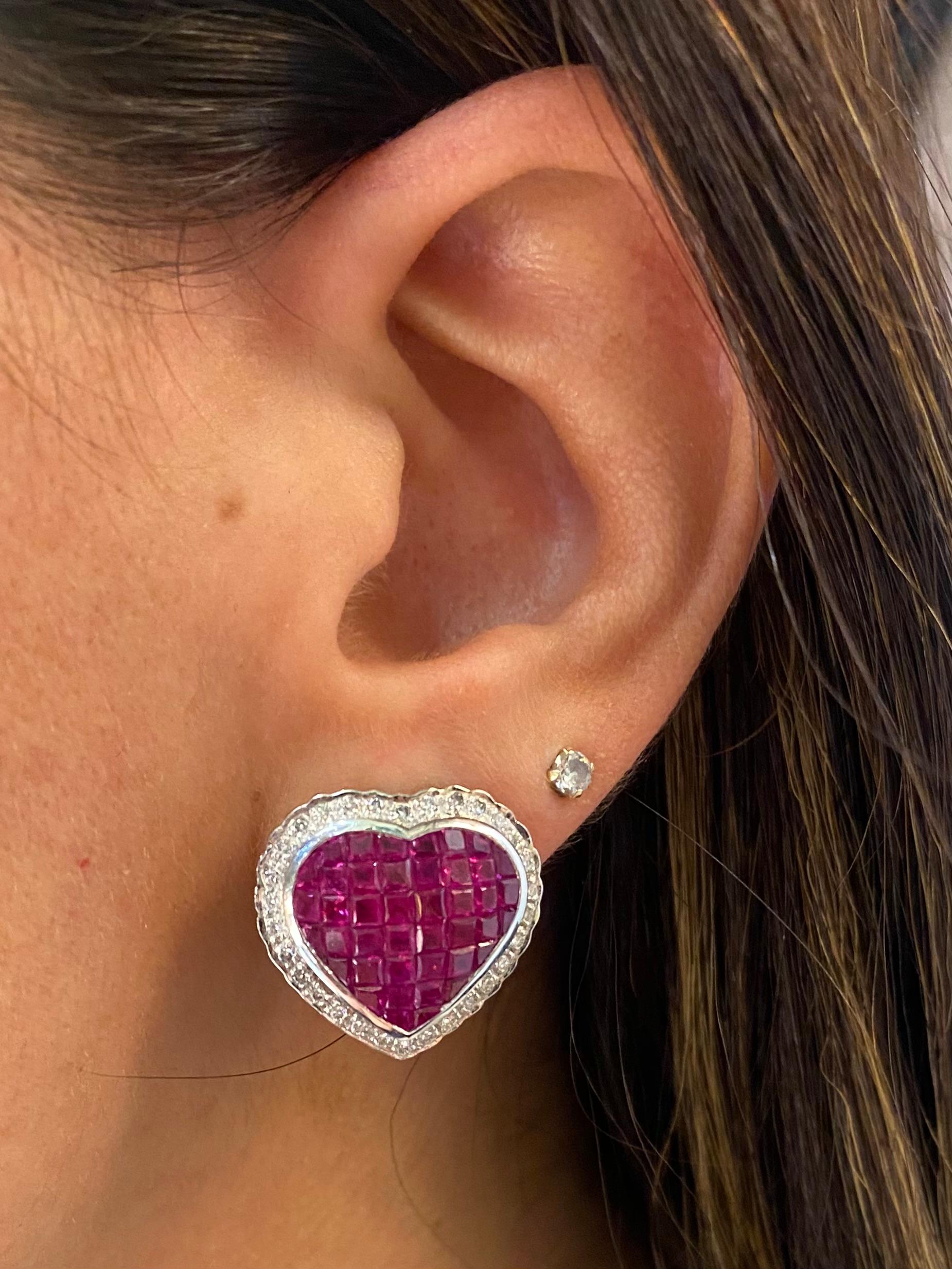 Mystery Set Ruby & Diamond Heart Earrings

A pair of 18 karat white gold heart shaped earrings set with 84 square cut rubies and 60 round cut diamonds

Stamped 750

Measurements: 0.75