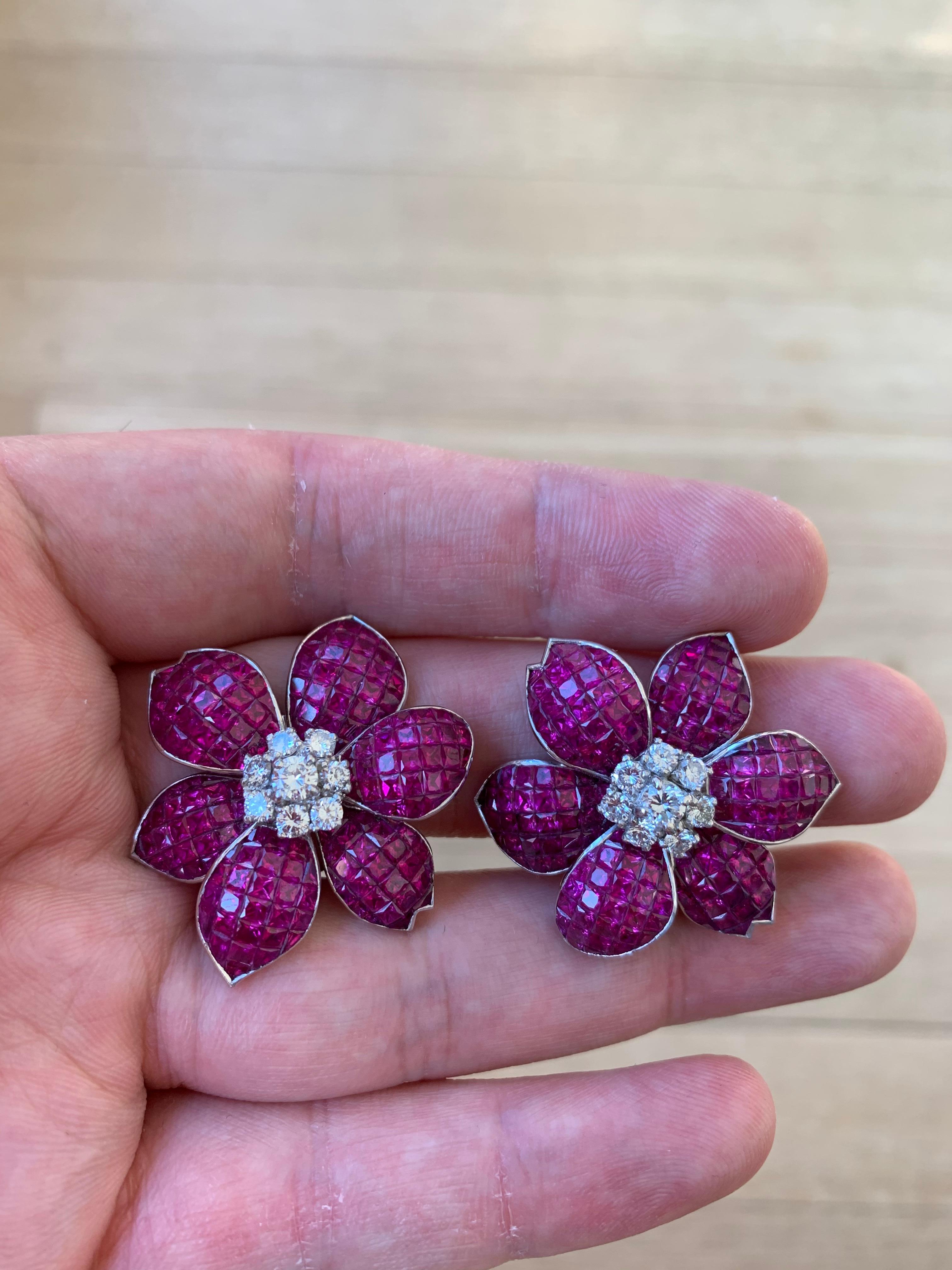 Mystery Set (or invisible set) ruby and diamond Flower Earrings

Approx 1.43 ct diamond and 38.05 ct rubies 

Set in Platinum