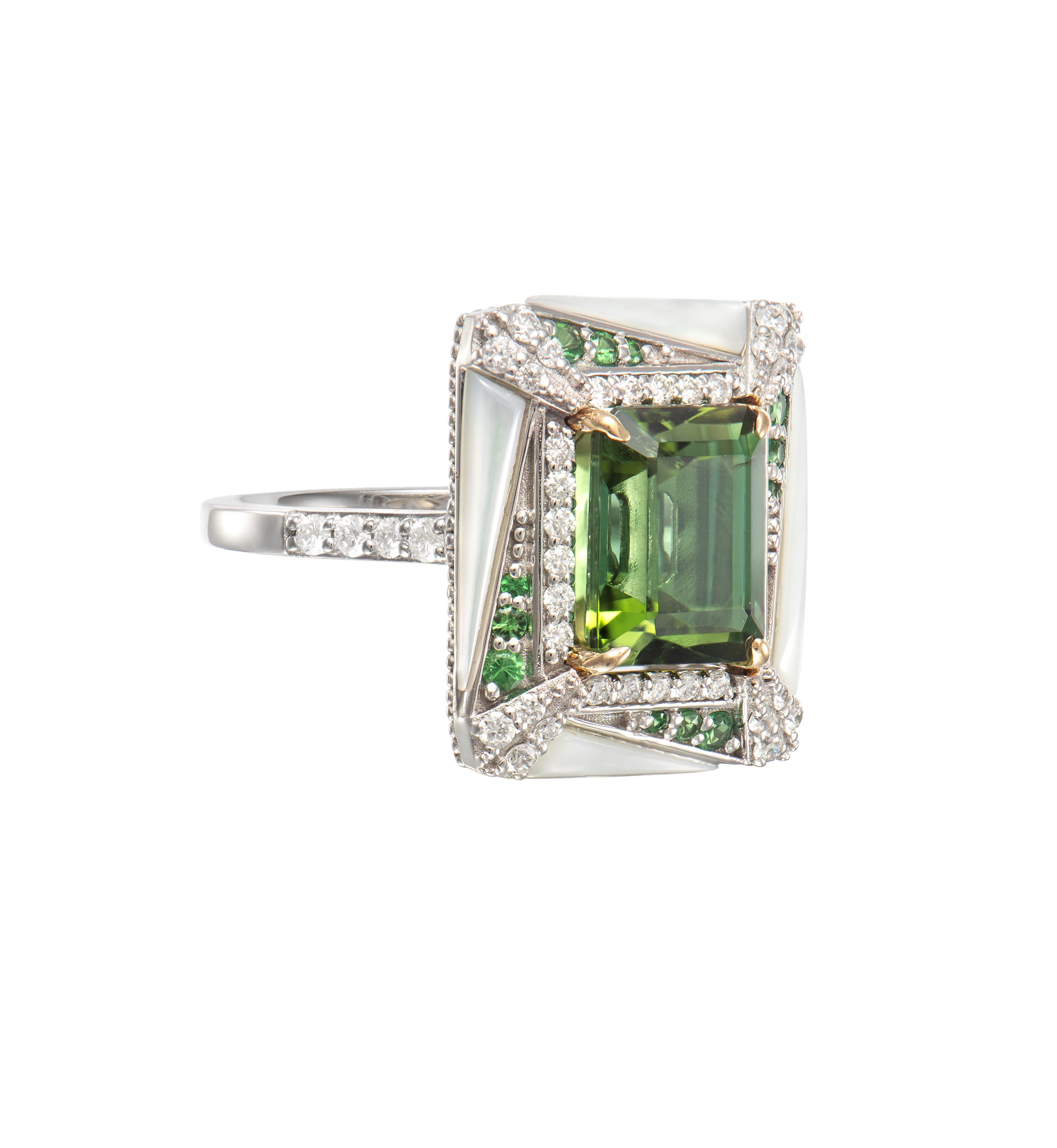 Mystic Green Tourmalines centred on an irregular frame of Tsavorites, Mother of Pearl and Diamonds. Combined with subtle gold detailing the tourmalines are hypnotising with its deep green hue.

Mystic Green Tourmaline Ring with Tsavorites, Mother of