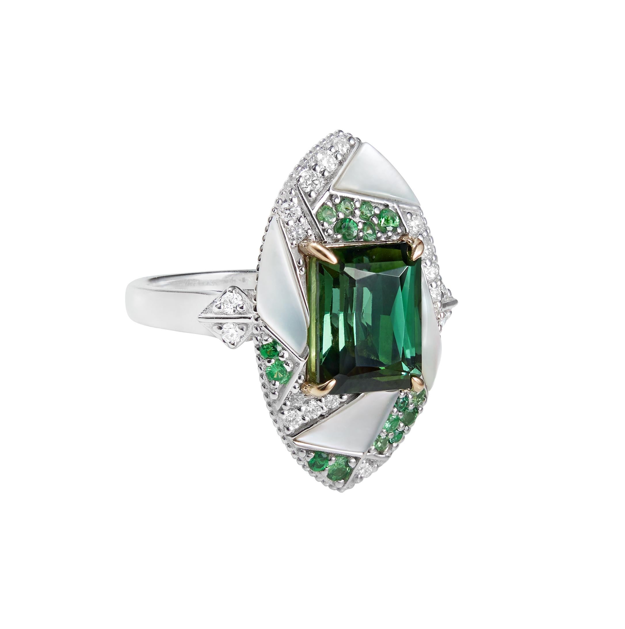 Mystic Green Tourmalines centered on an irregular frame of Tsavorites, Mother of Pearl and Diamonds. Combined with subtle gold detailing the tourmalines are hypnotising with its deep green hue.

Mystic Green Tourmaline Ring with Tsavorites, Mother