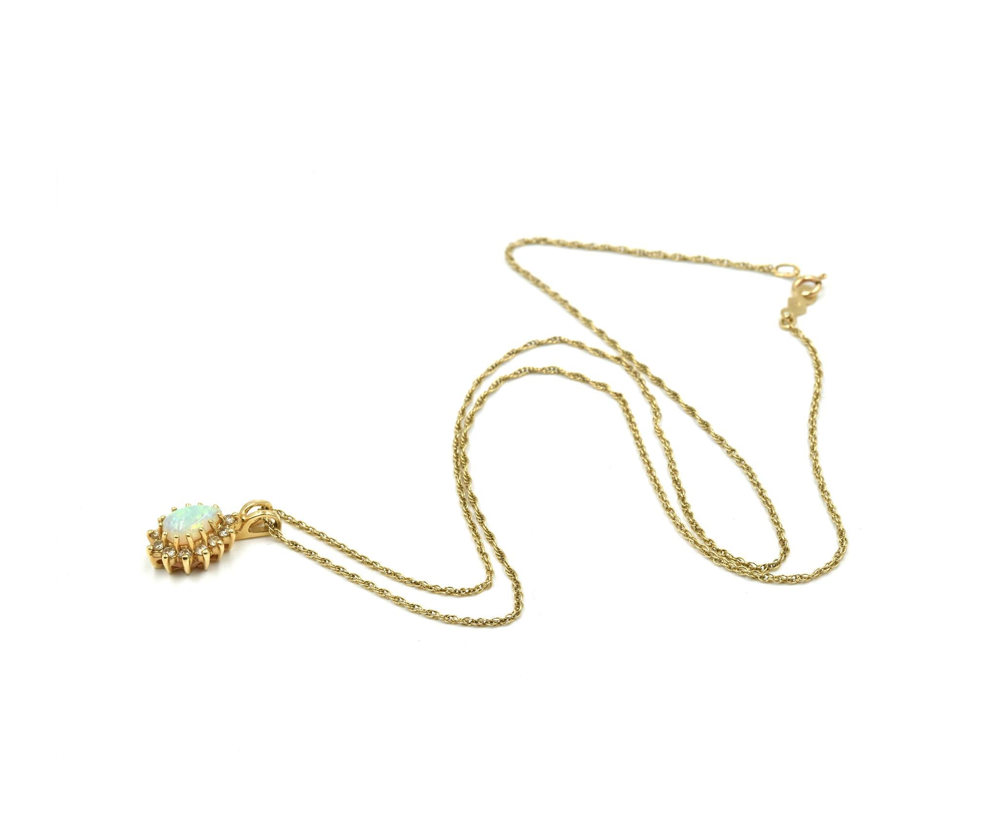 Designer: custom design
Material: 14k yellow gold
Gemstone: cabochon mystic opal gemstone
Diamonds: 12 round brilliant cut diamonds = 0.12 carat total weight
Dimensions: necklace measures 18 inches long
Weight: 2.29 grams
