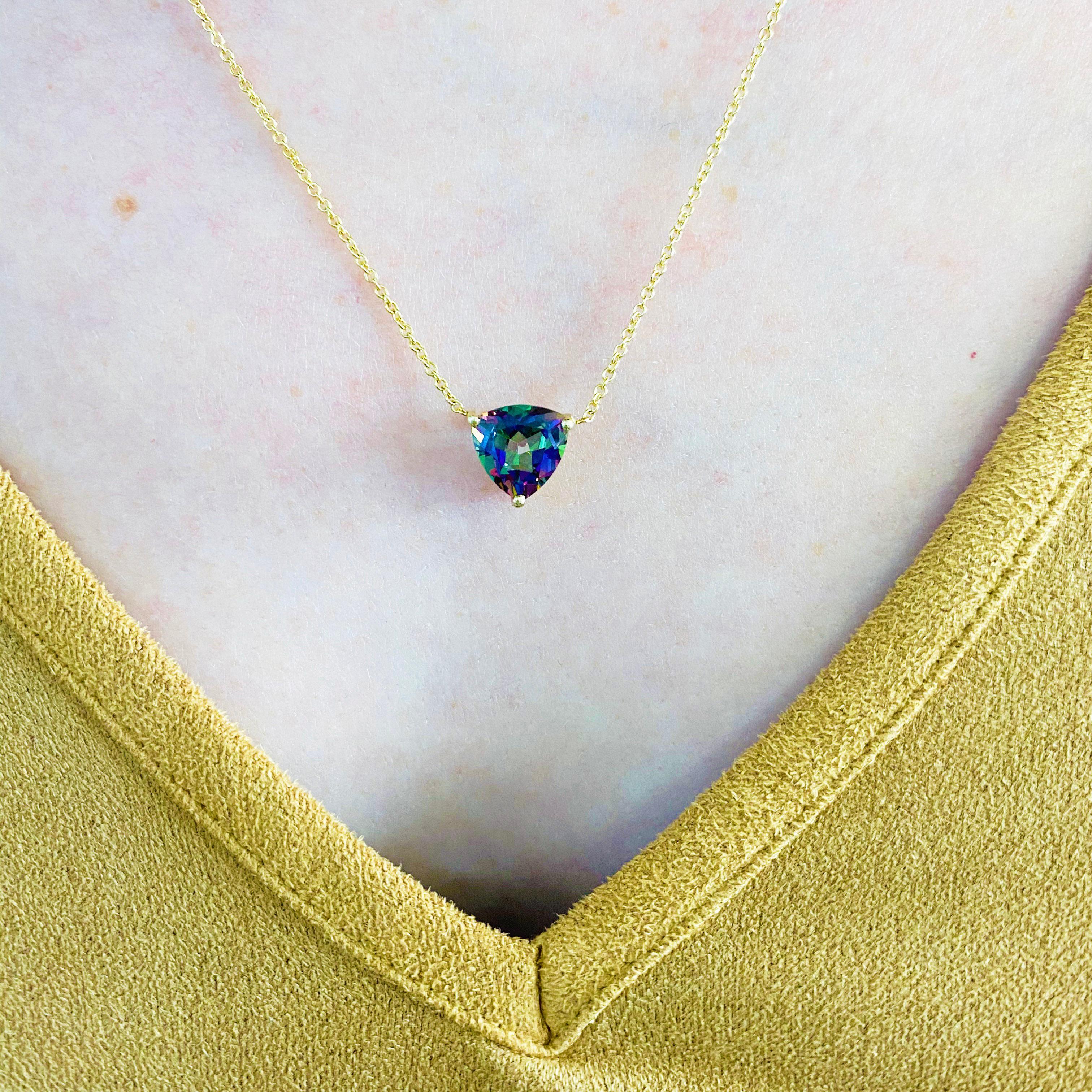 This beautiful vibrant trillion cut mystic topaz set in polished 14k yellow gold provides a look that is very modern yet classic! You won't believe how stunning and colorful this stone is. This necklace is very fashionable and can add a touch of