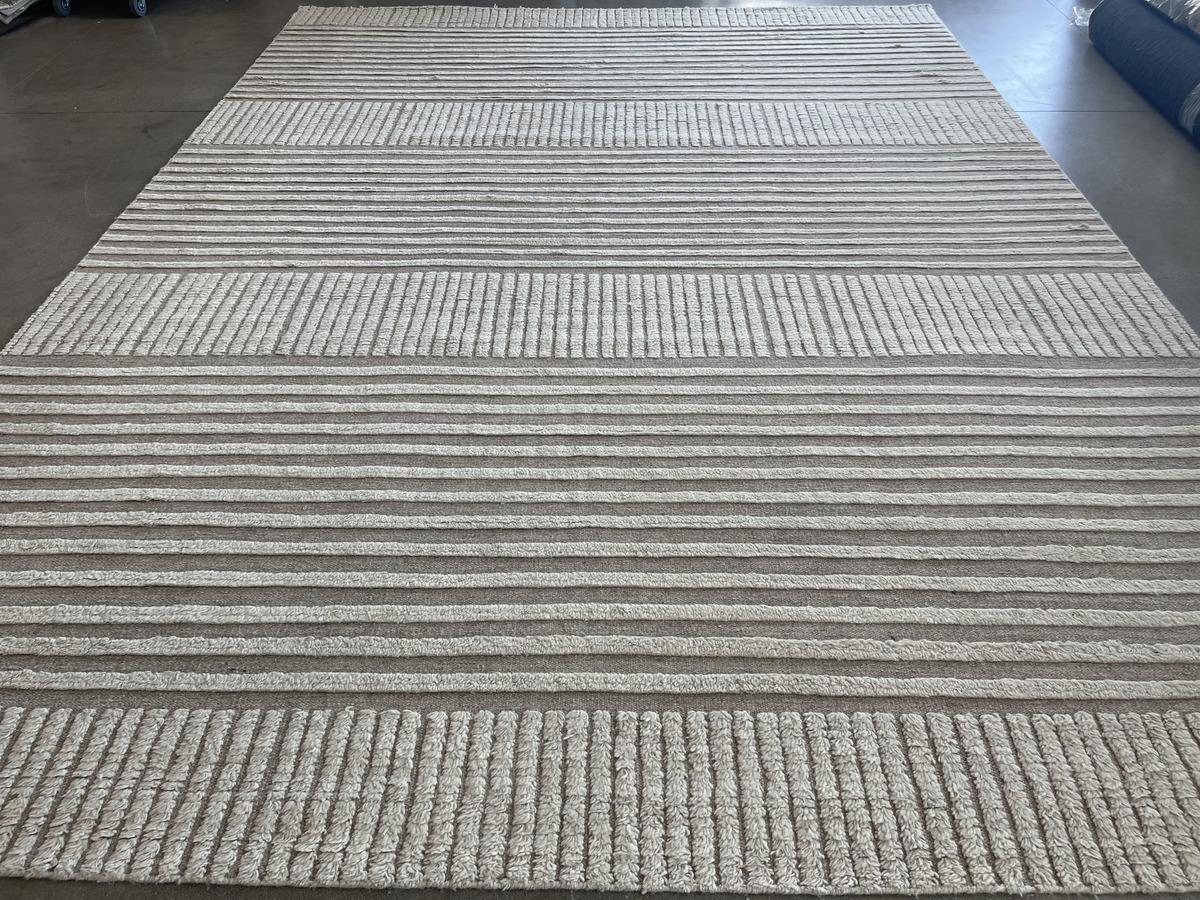 From the popular Mystic Collection comes this stunning wool area rug featuring a simple cut and loop design in natural colors. Eye-catching on its own or as a base to complement a wide range of design styles. Hand made in India using vegetal dyes.