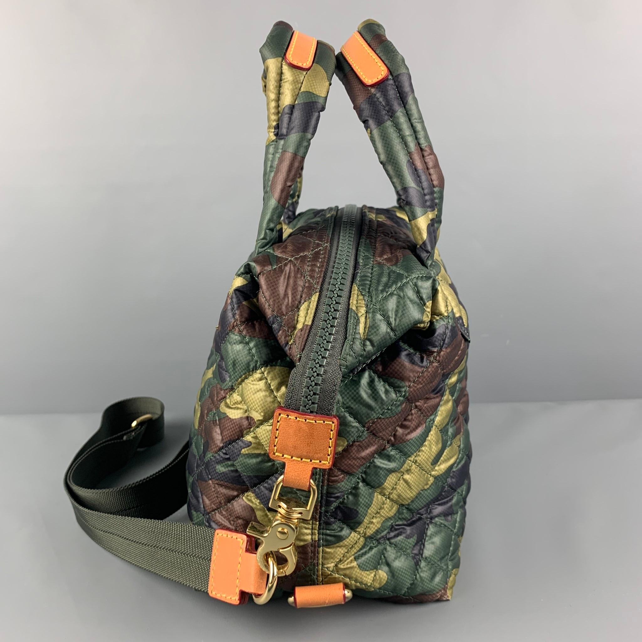 MZ WALLACE bag comes in a green & olive camouflage quilted nylon featuring top handles, leather trim, detachable cross body strap, inner pocket, and a top zipper closure. 

Very Good Pre-Owned Condition.

Measurements:

Length: 9 in.
Width: 5