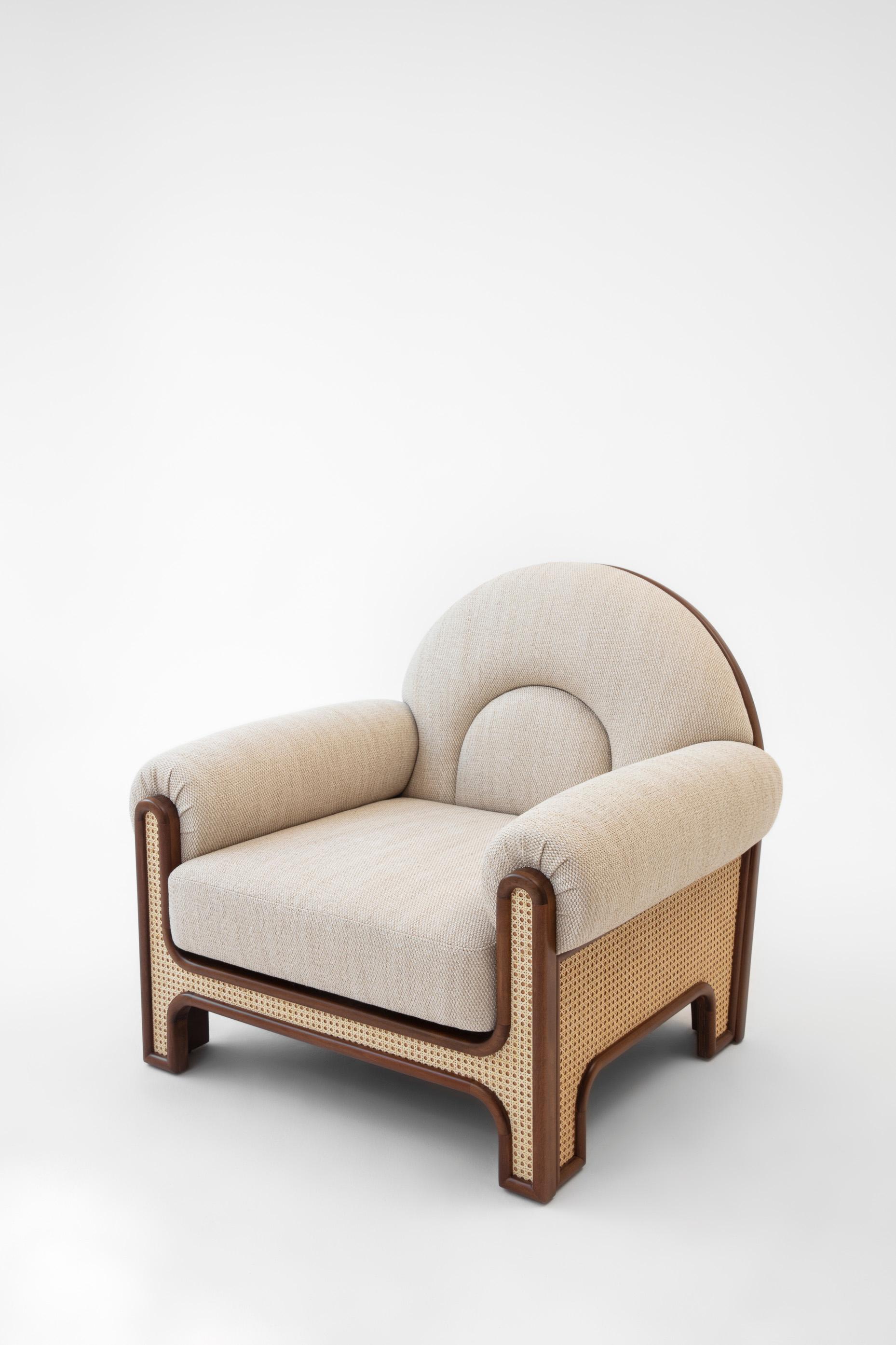 The N-gene armchair is a reinterpretation of an armchair designed by Merve’s uncle, interior designer, Engine, in the 1970s. The N-Gene is re-envisioned with caning, and is upholstered in beige colored fabric. This entirely handcrafted armchair is